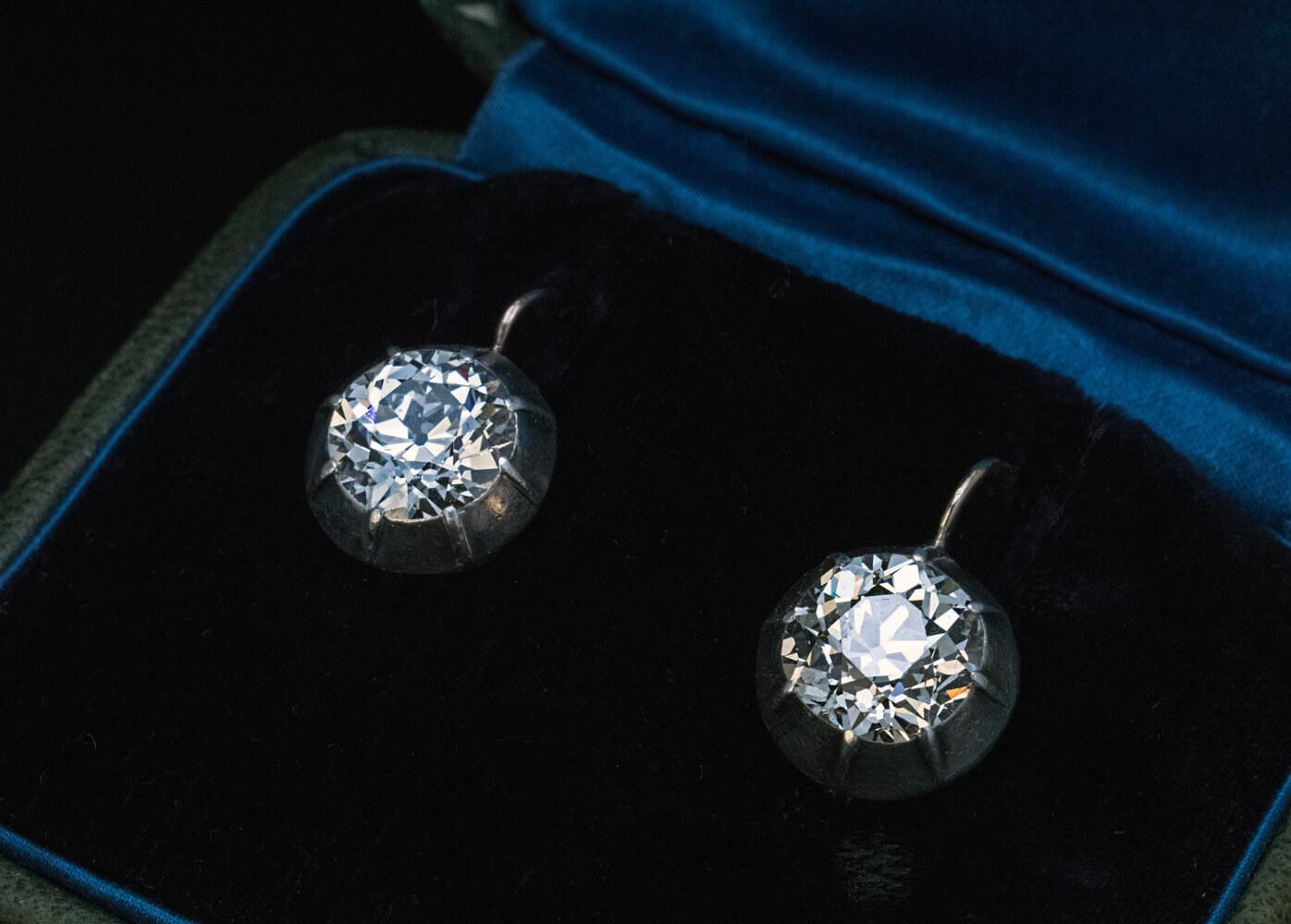 These early 1900s antique earrings are crafted in silver-topped 14K gold (front – silver, back – gold). The earrings are set with two high quality Old European cut diamonds: 8.86 – 8.64 x 5.70 mm, approximately 2.89 ct, I-J color, VS1 clarity and