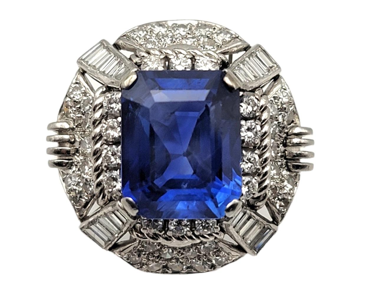 Absolutely breathtaking, rare emerald cut sapphire and diamond vintage cocktail ring. The brilliant blue stone against the bright white diamonds really catches the viewers eye. Exquisite detail work combined with the incredible, untreated sapphire
