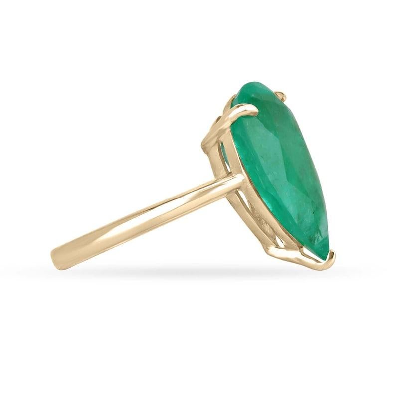 Elevate your jewelry collection with our stunning Solitaire Colombian Emerald Ring, showcasing an extraordinary 6.28-carat pear-cut Colombian emerald of remarkable rarity and beauty. This lustrous gem radiates with a vivid and rich apple-green hue,