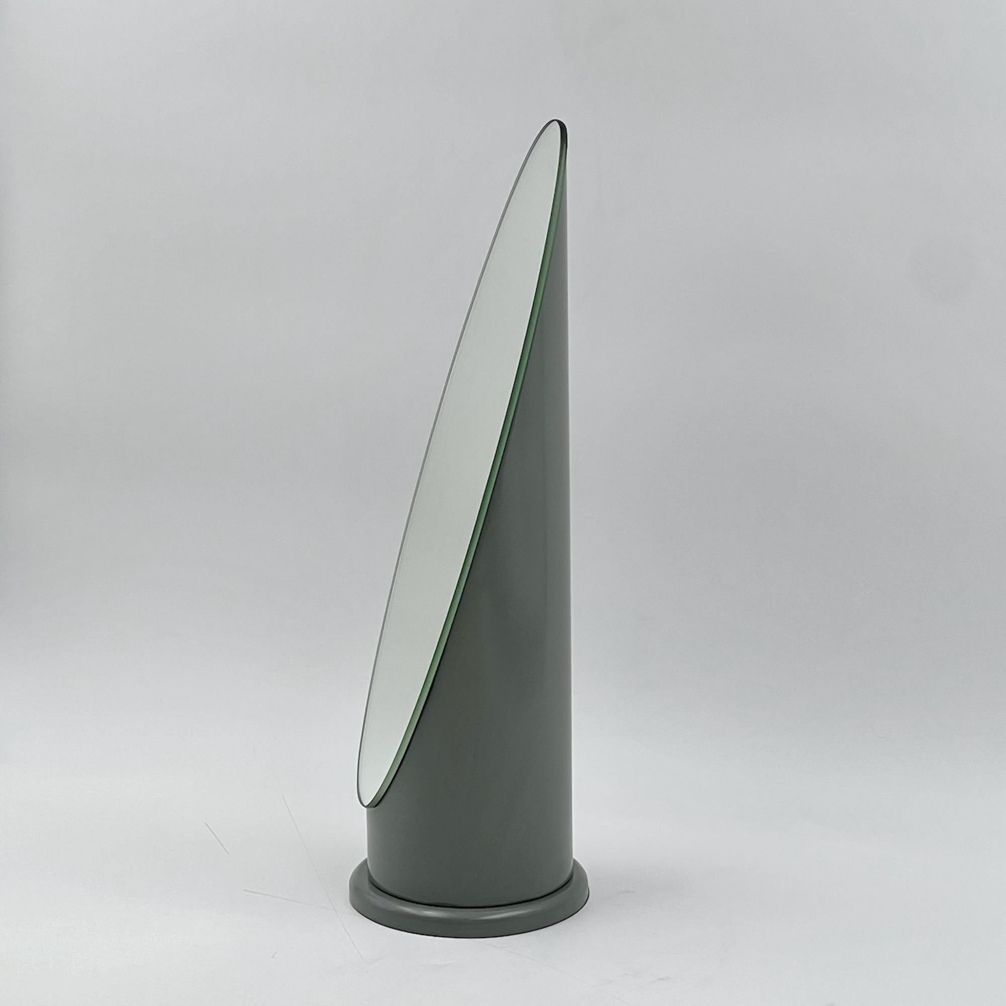 A rare and lovely table mirror with the timeless ‘Lipstick’ design created by Rodolfo Bonetto and produced in Italy in the 70s. 

This design classic is made of a round plastic structure with lacquered grey finish. The vertical shape resembles a