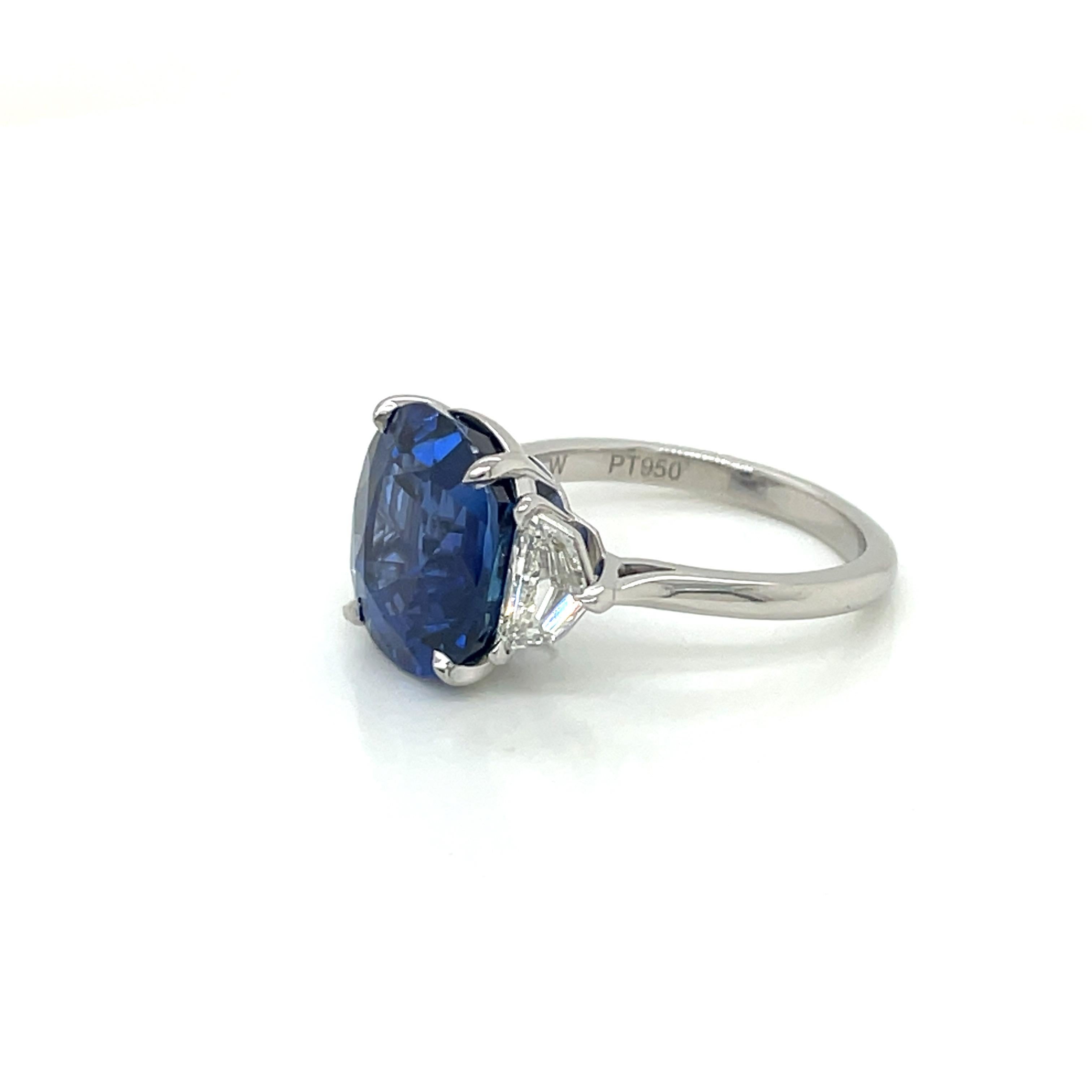 This new and exceptional 7.63 carat no heat Burmese sapphire is set in a handmade platinum setting. This stunning sapphire is flanked by a pair of white Cadillac-shaped side diamonds weighing .73cttw, F color, VS clarity.

This sapphire is rare and
