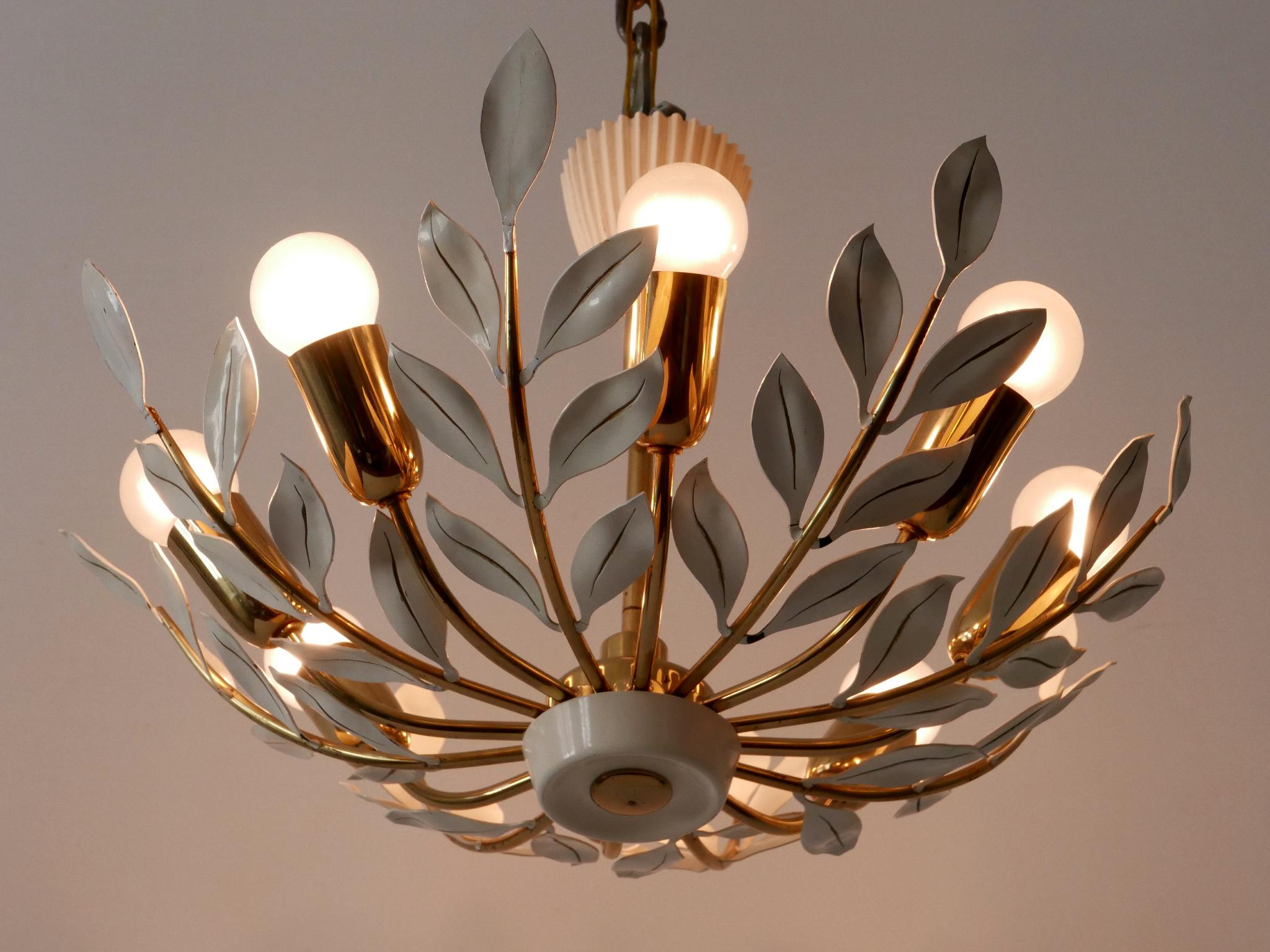Rare, elegant & highly decorative Mid-Century Modern 8-flamed chandelier or pendant lamp. Designed and manufactured by Vereinigte Werkstätten, Germany, 1950s.

Executed in brass and metal, the chandelier needs 8 x E14 / E12 Edison screw fit bulbs.