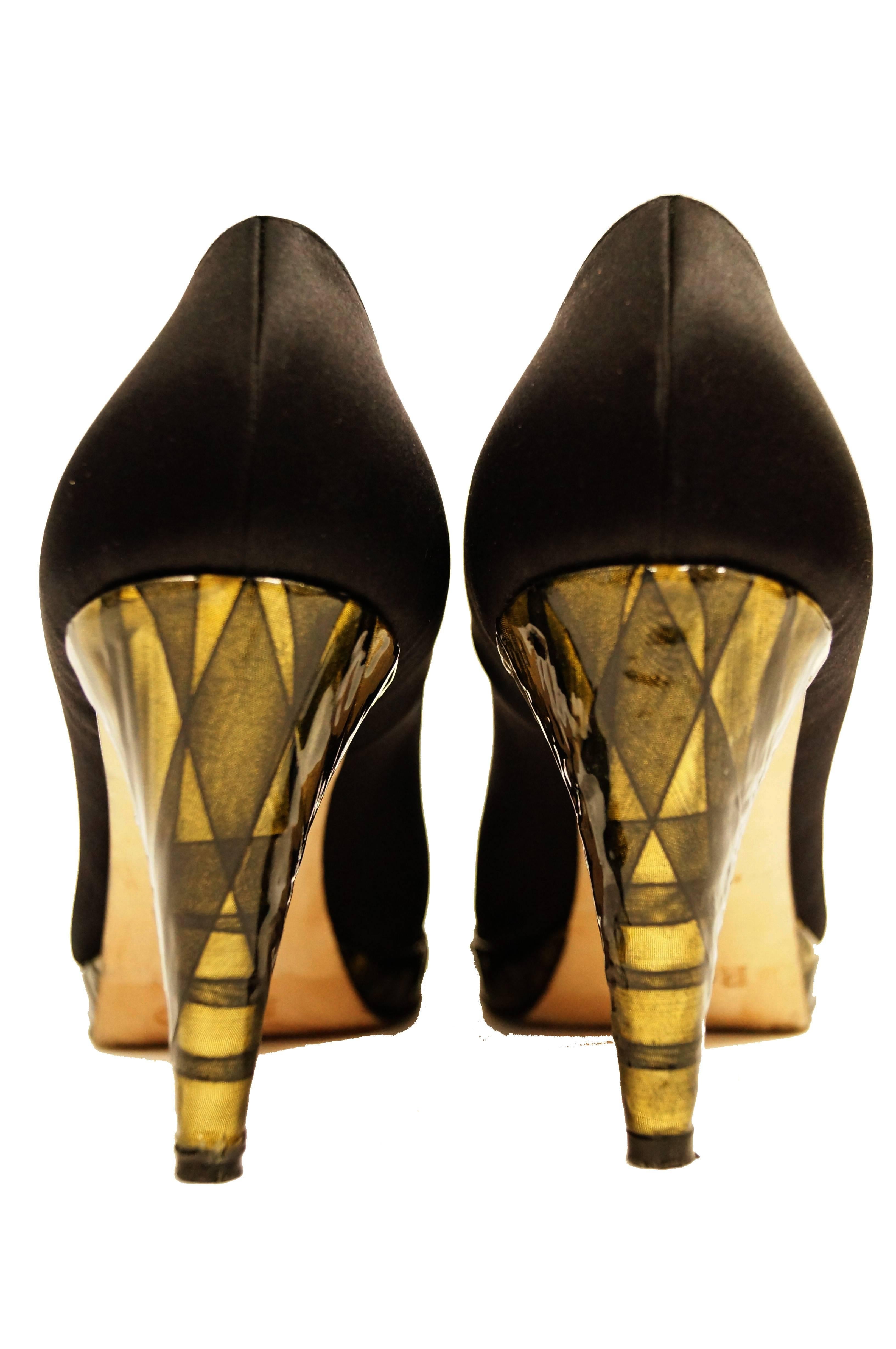 Fabulous black satin and gold pumps by Rodo!  Extremely hard to purchase on the second dary market as most remain coveted by their original owners.  Pumps feature traditional mid level vamp with high ankle, contrasting with avant-garde gold base