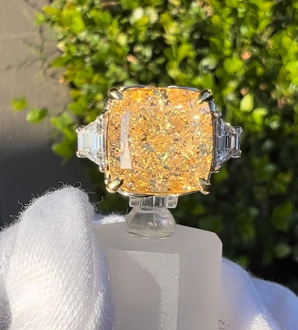 Scintillating, rare and very collectible, ladies 18 karat white and yellow gold 3 stone 9.68 carat total weight diamond ring features in the center one GIA Certified Internally Flawless Cushion Modified Brilliant cut fancy yellow diamond weighing