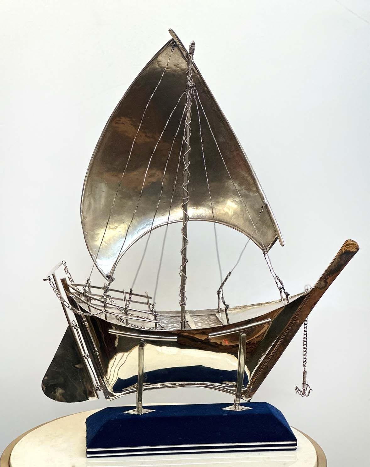 Rare 925 sterling silver boat sculpture on a lined blue velvet stand. Great detail all around making this an important piece. 
Dimensions:
24