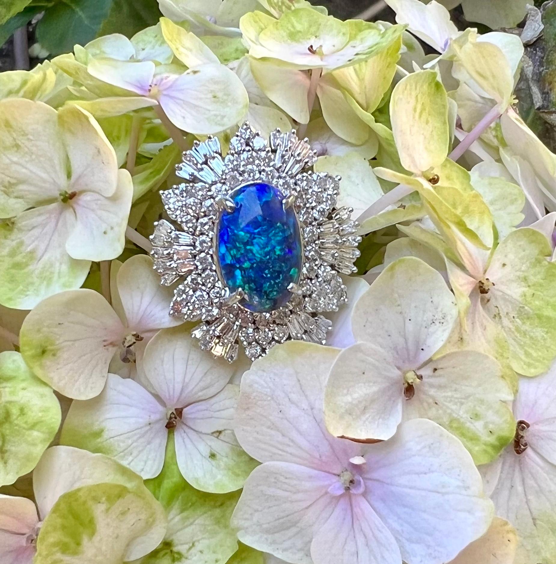 Captivating, cobalt and turquoise blue colored oval cut natural Australian black opal and diamond large estate cocktail ring is set in 14 karat white gold. This is a natural black opal and is NOT a triplet or doublet. The black cabochon opal