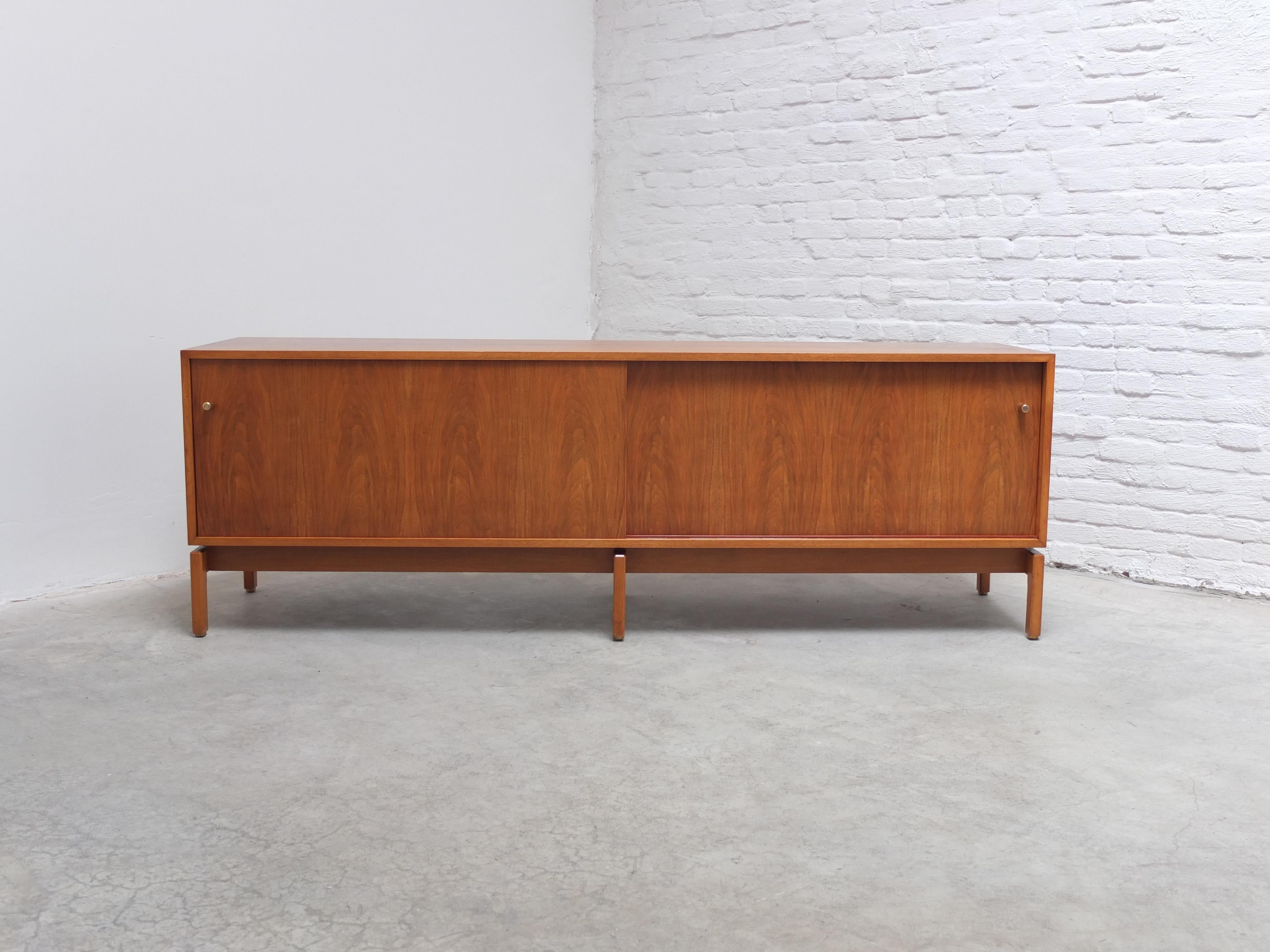 Unique sideboard with sliding doors from the ‘Abstracta’ series designed by Jos De Mey for Van Den Berghe-Pauvers during the 1960s. Remarkable is the low height of this model which is uncommon and makes it perfect as a tv stand for example. The