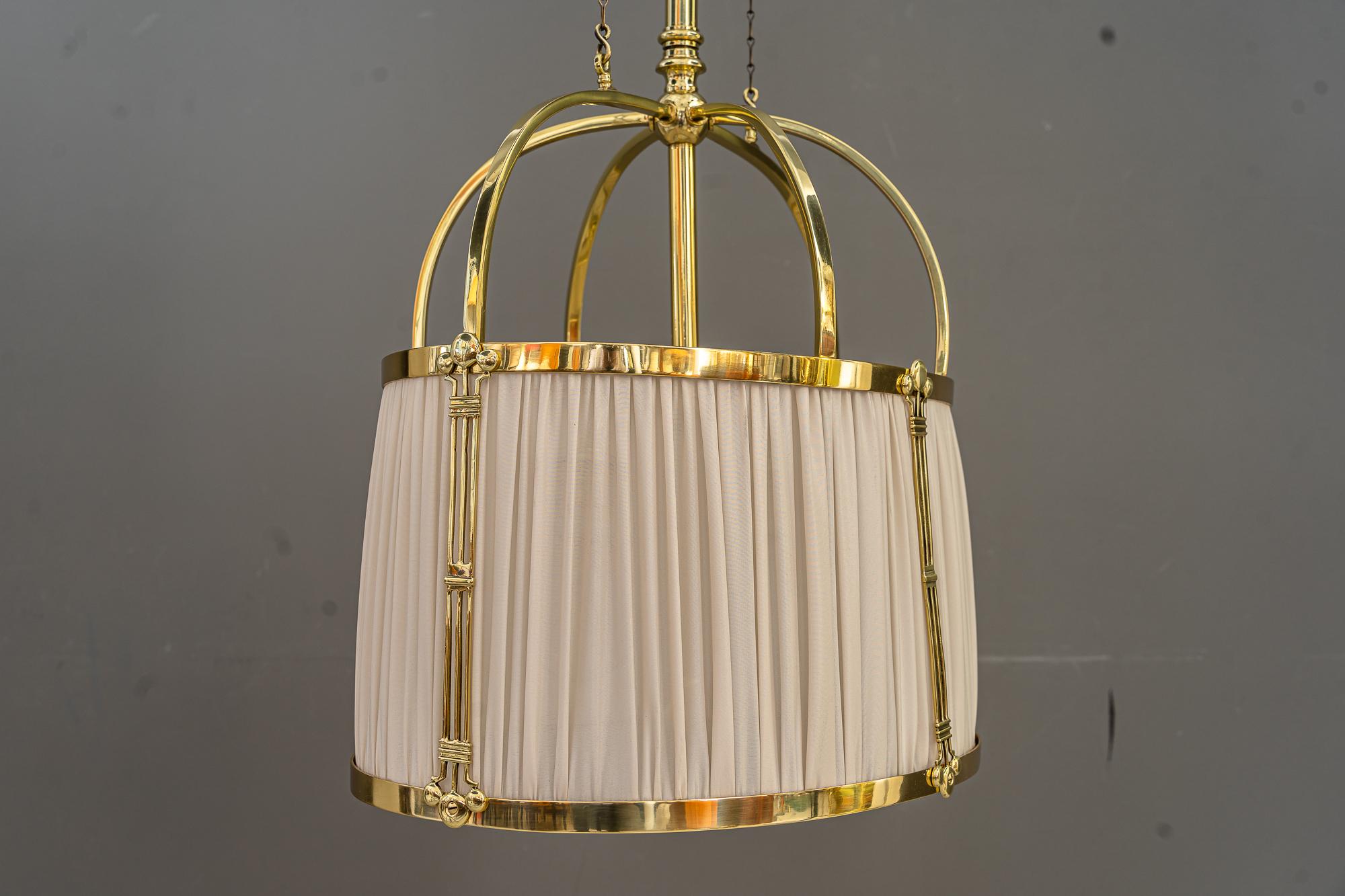 Rare adjustable Art Deco chandelier with fabric shade around 1920s
The fabric is replaced
Brass polished and stove enameled
Adjustable from 140cm - 165cm.