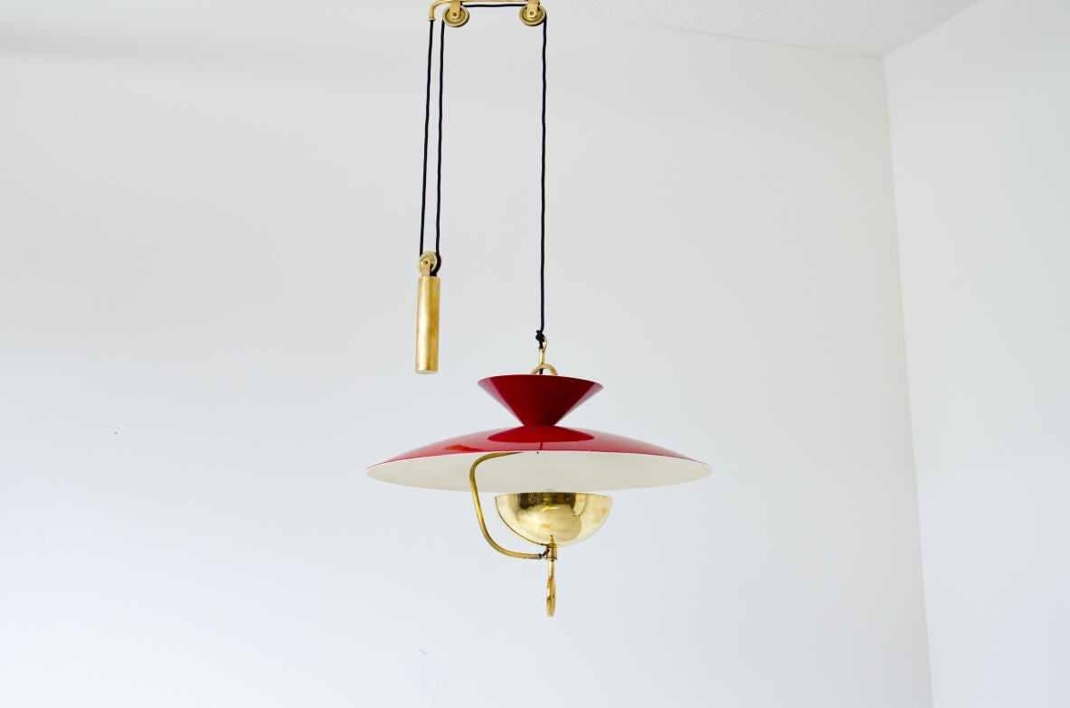 Rare adjustable chandelier in lacquered metal and brass with counterweight and pulleys.

Italian manufacture, 1940s.

 