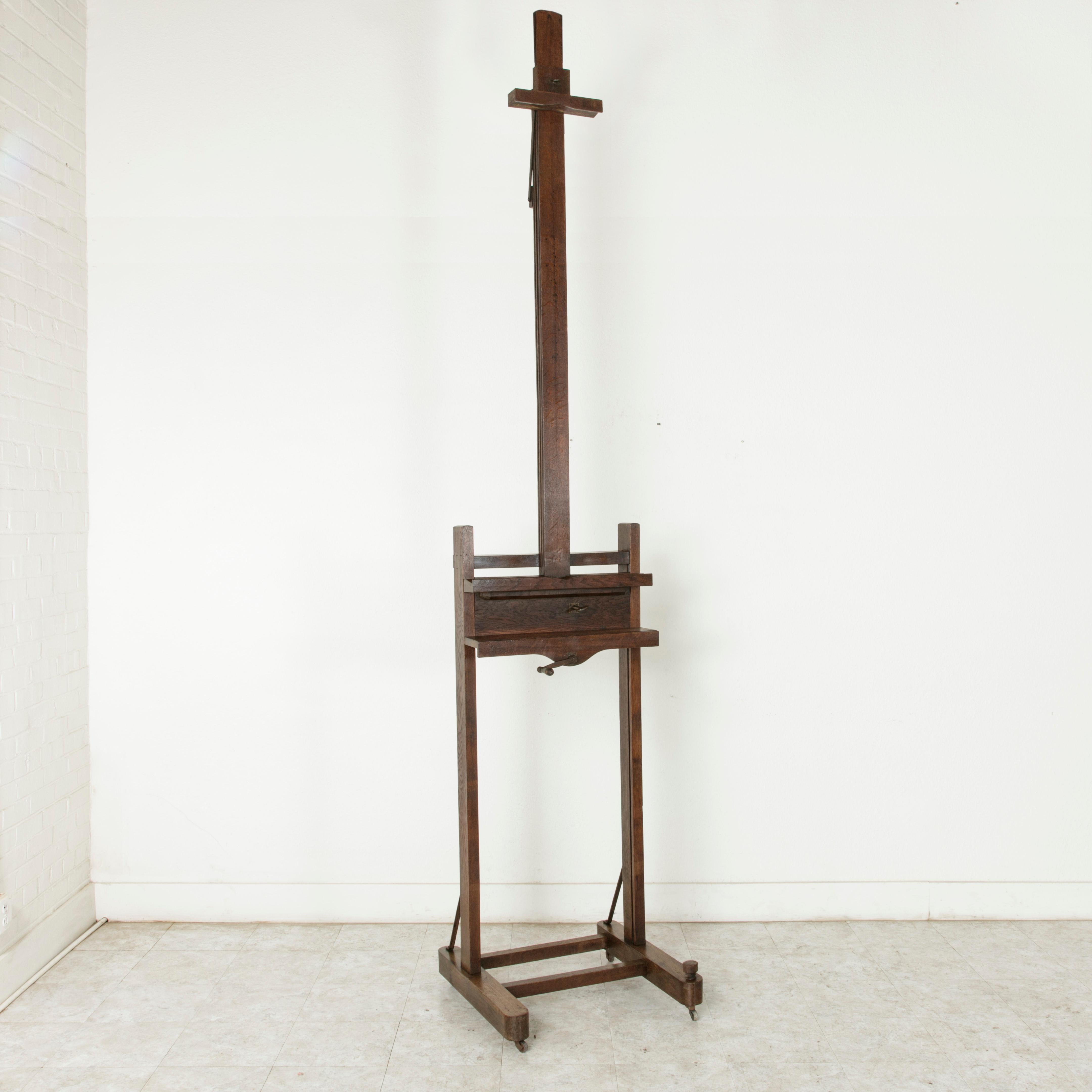 Exceptionally rare! This very large oak floor easel from the late 19th century was originally used in a French gallery for exhibiting art. An extraordinary find, this easel features a double mechanism, with a crank allowing for the height to be