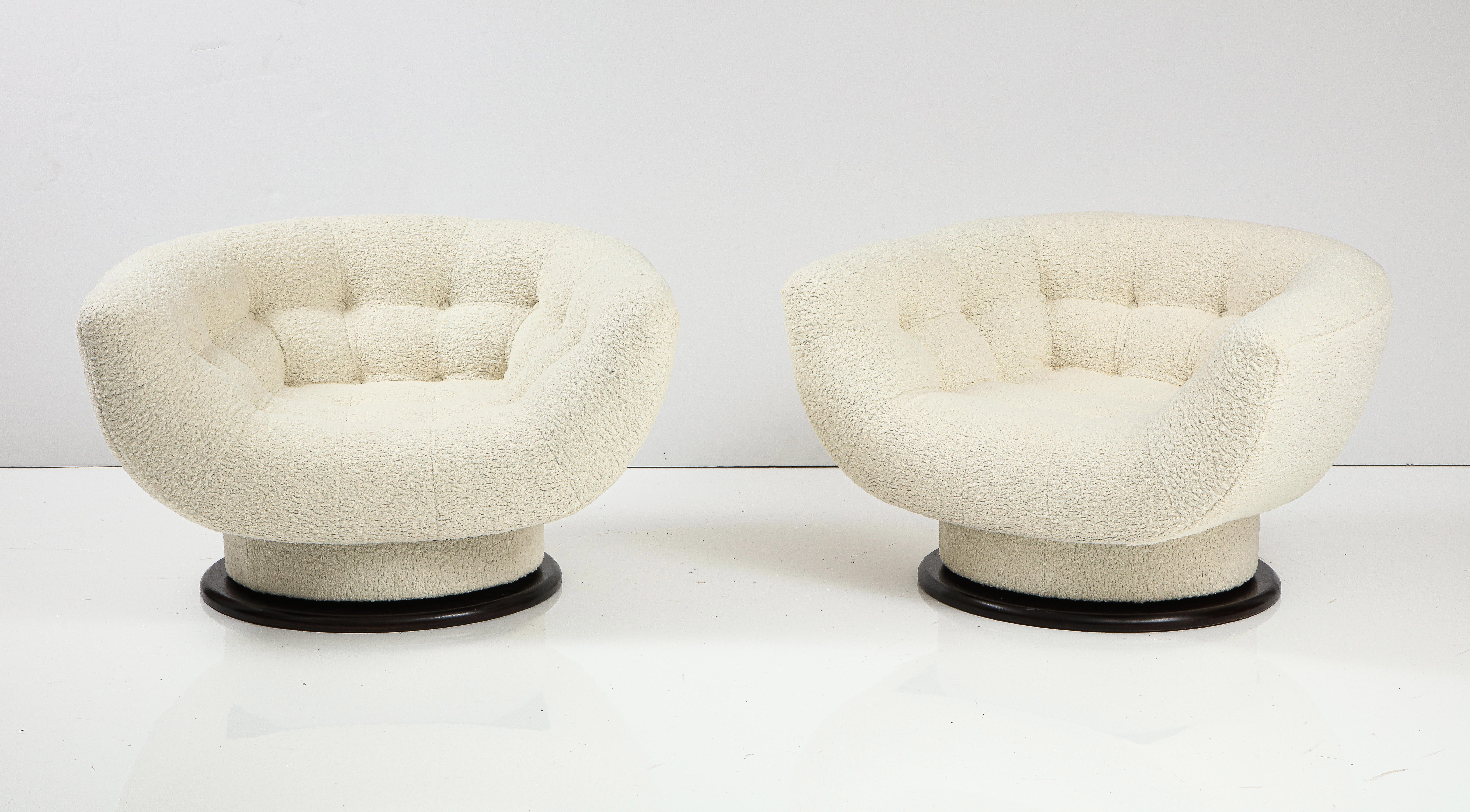 Stunning pair of rare oversize swivel lounge chairs designed by Adrian Pearsall, Fully restored and reupholstered in Bouclé fabric, in walnut base they swivel 360 degrees.