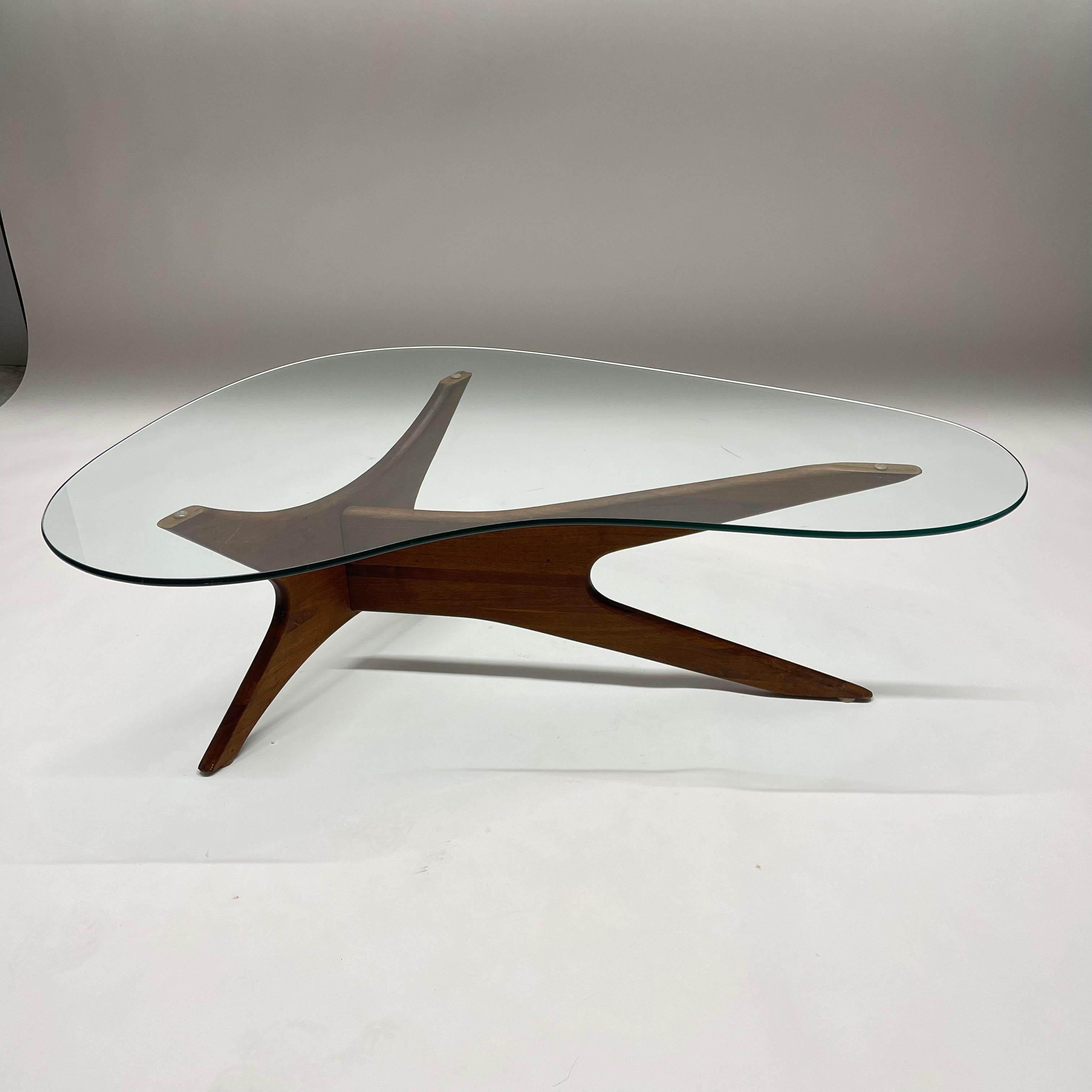 Rare and unique biomorphic kidney shaped coffee or cocktail table rendered in walnut with original glass top, designed by Adrian Pearsall for Craft Associates, Wilkes-Barre , Pa, circa 1960s.
