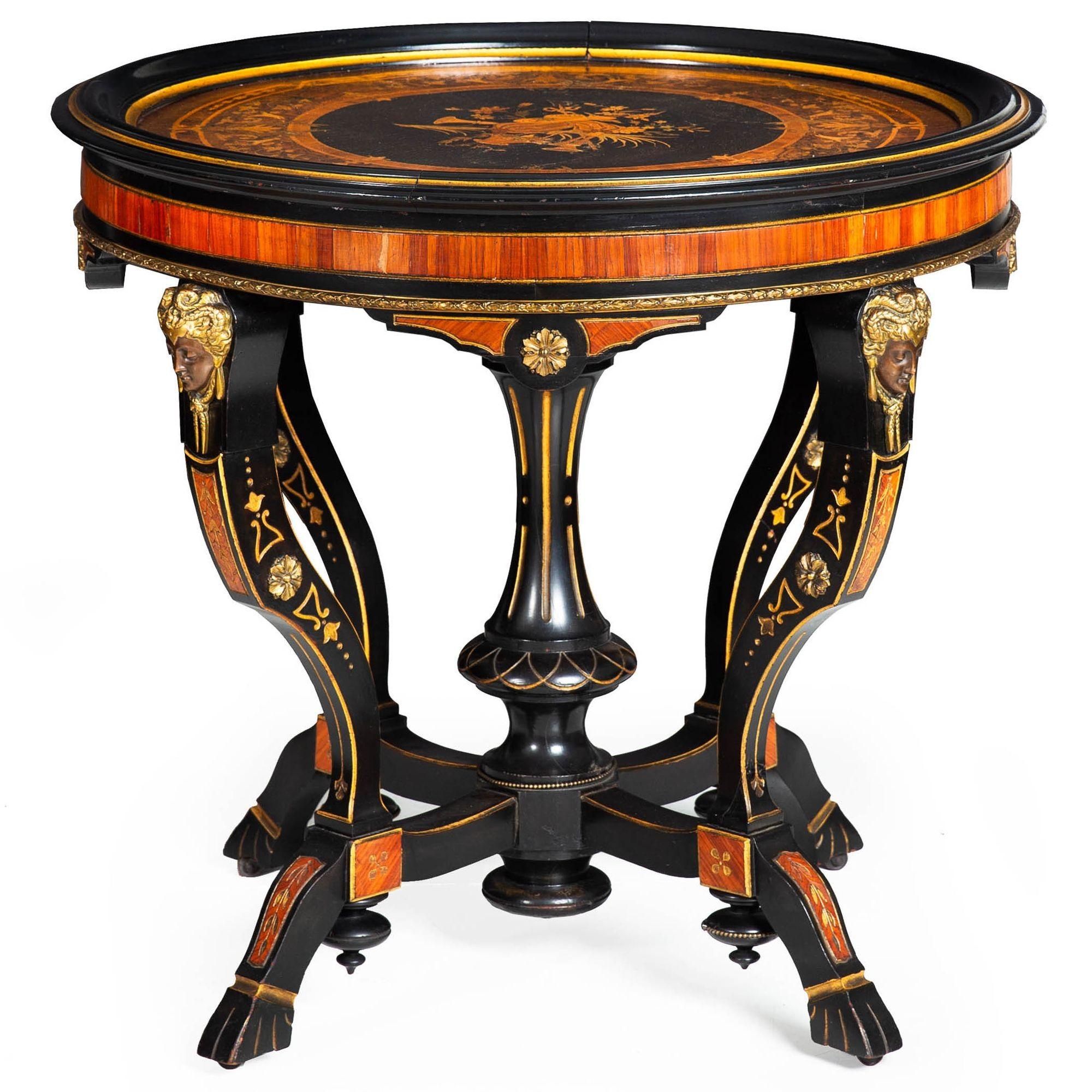A RARE AESTHETIC MOVEMENT EBONIZED MARQUETRY-INLAID PARCEL GILT CENTER TABLE WITH BRONZE MASKS OF DIANA OF ANET
In the manner of Pottier & Stymus of New York  unmarked  ca. 1870
Item # 402NOP08A 

An elegant low table of the Aesthetic Movement circa