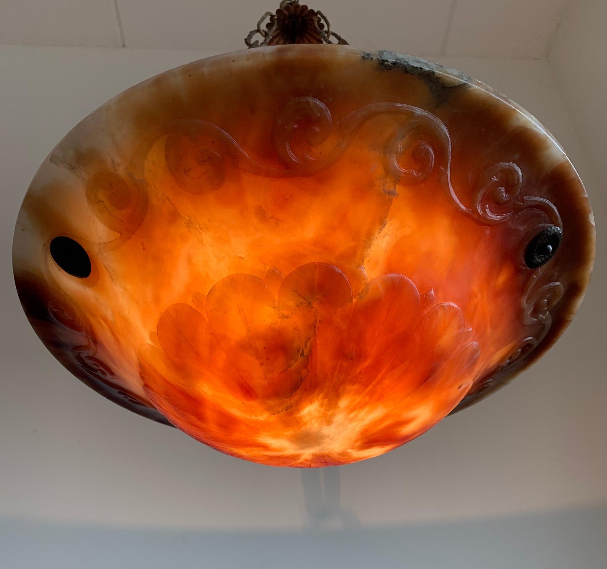 One of a kind in shape and colors, alabaster light fixture.

If you are looking for a great quality and striking colors pendant then this turn of the century example could be the one for you. The practical size alabaster shade comes with hand-carved