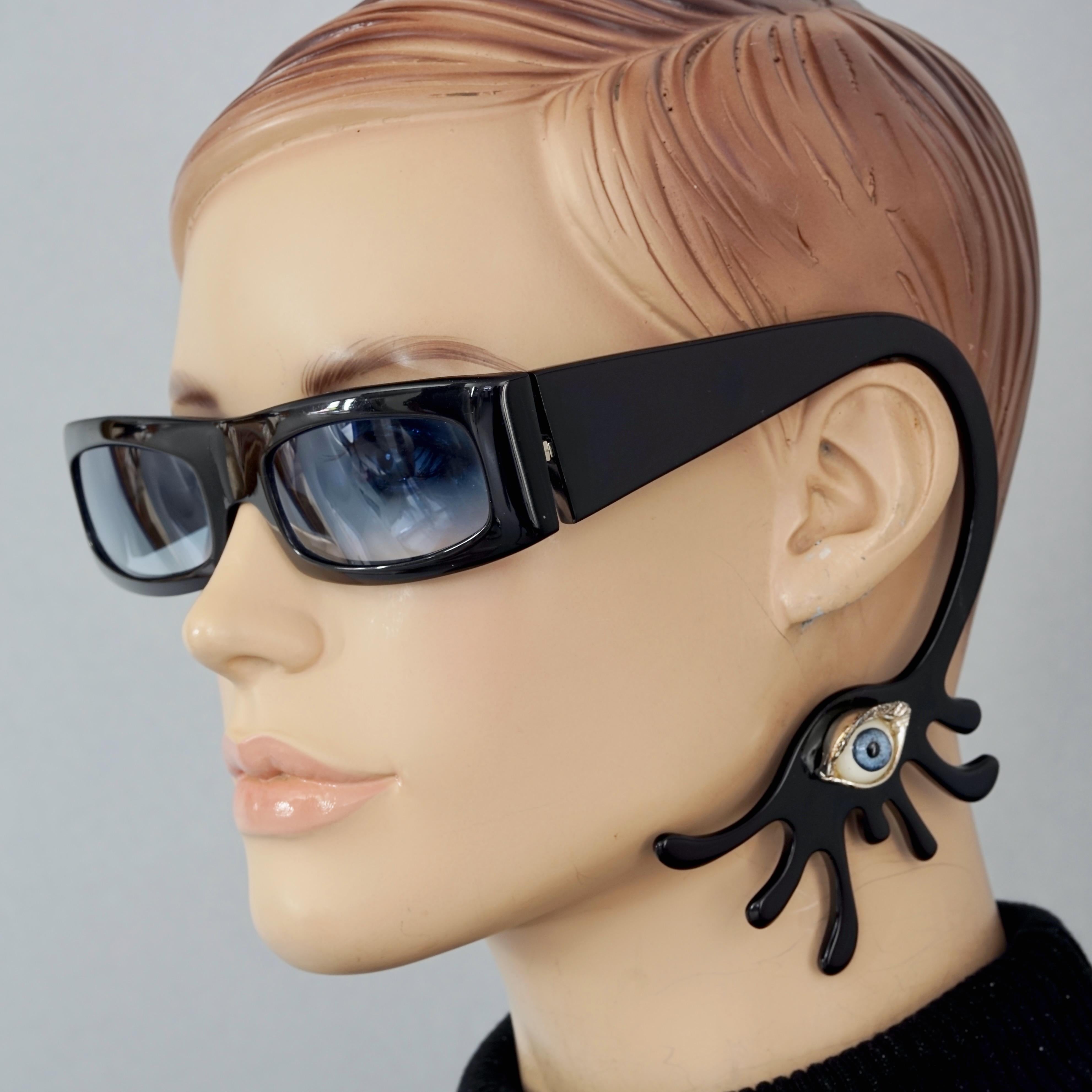 RARE Alain MIKLI and Delfina DELLETREZ Murano Evil Eye Novelty Sunglasses

Measurements:
Height: 1.57 inches (4 cm)
Frame Width: 5.51 inches (14 cm)

Features:
- 100% Authentic Alain MIKLI and Delfina DELLETREZ collaboration sunglasses. 
- One ear