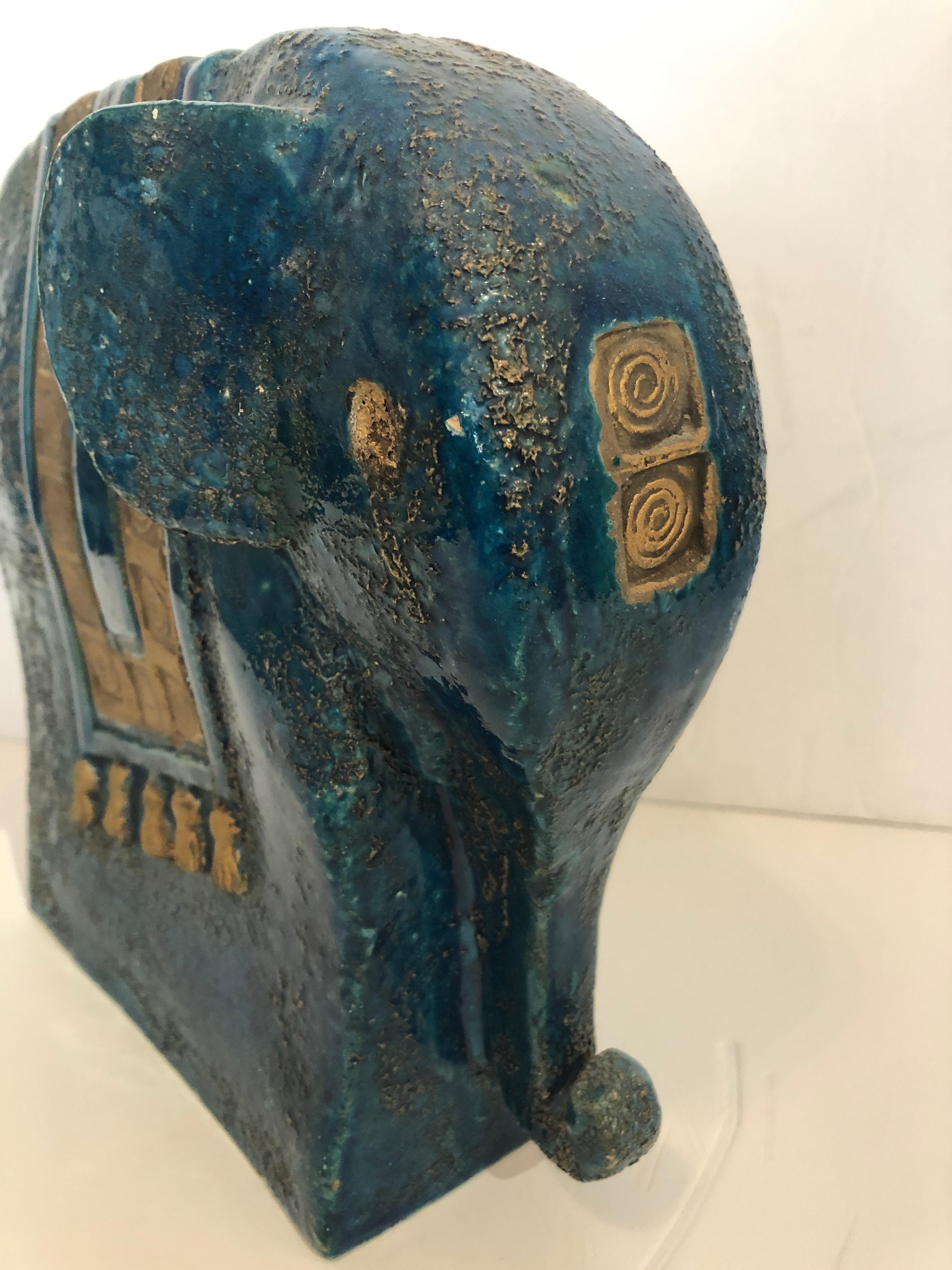 A rare fairly large whimsical elephant by Aldo Londi for Bitossi having gorgeous turquoise and gilded glaze, geometric decoration and tassels.