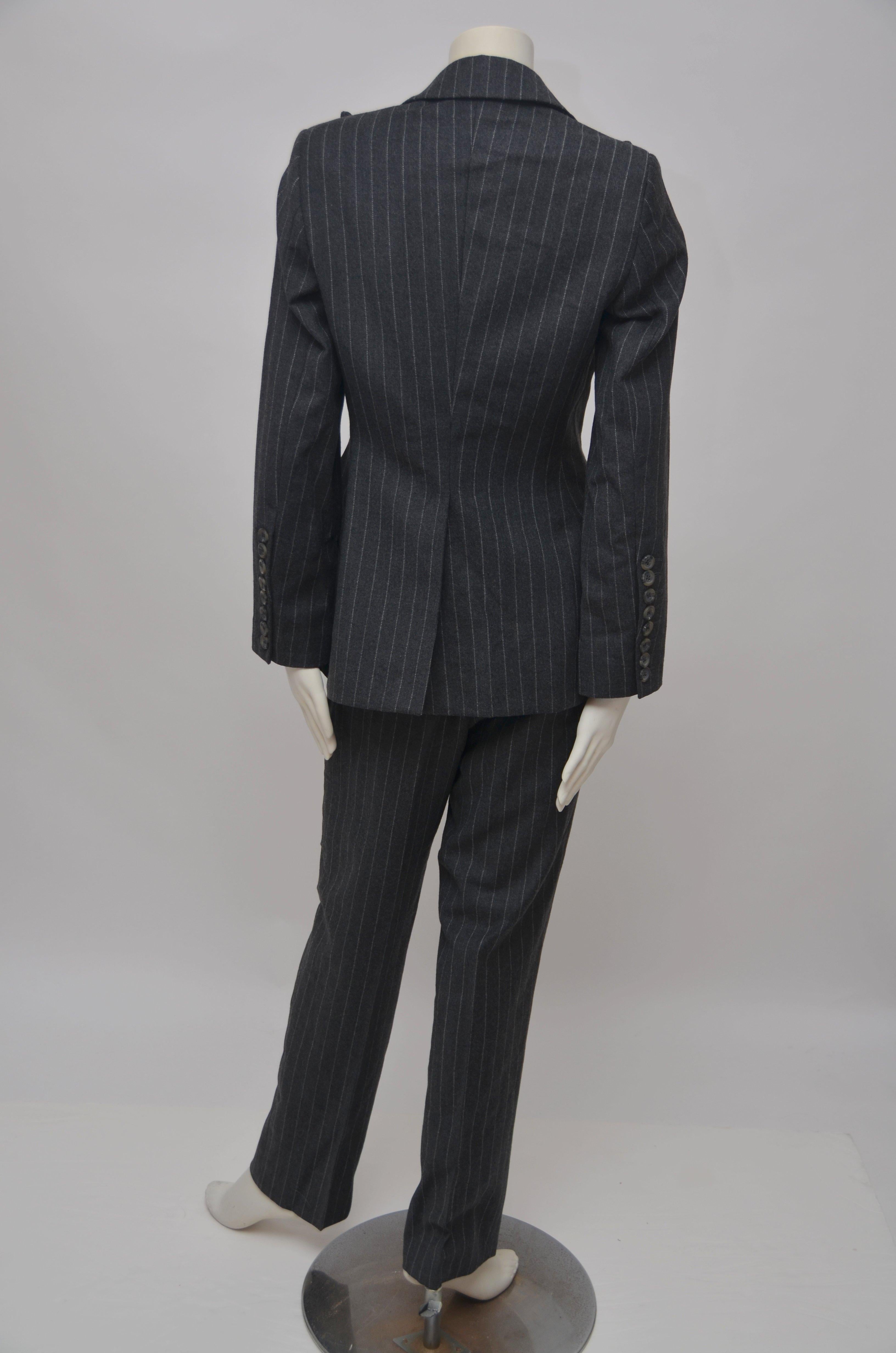ALEXANDER McQUEEN A/W 1996  Suit  With Hair / Birth Label
The label inside: a single lock of hair suspended within a clear plastic pocket. 
McQueen used these hair labels in some of his early collections including Banshee, Autumn/Winter 1994 and The