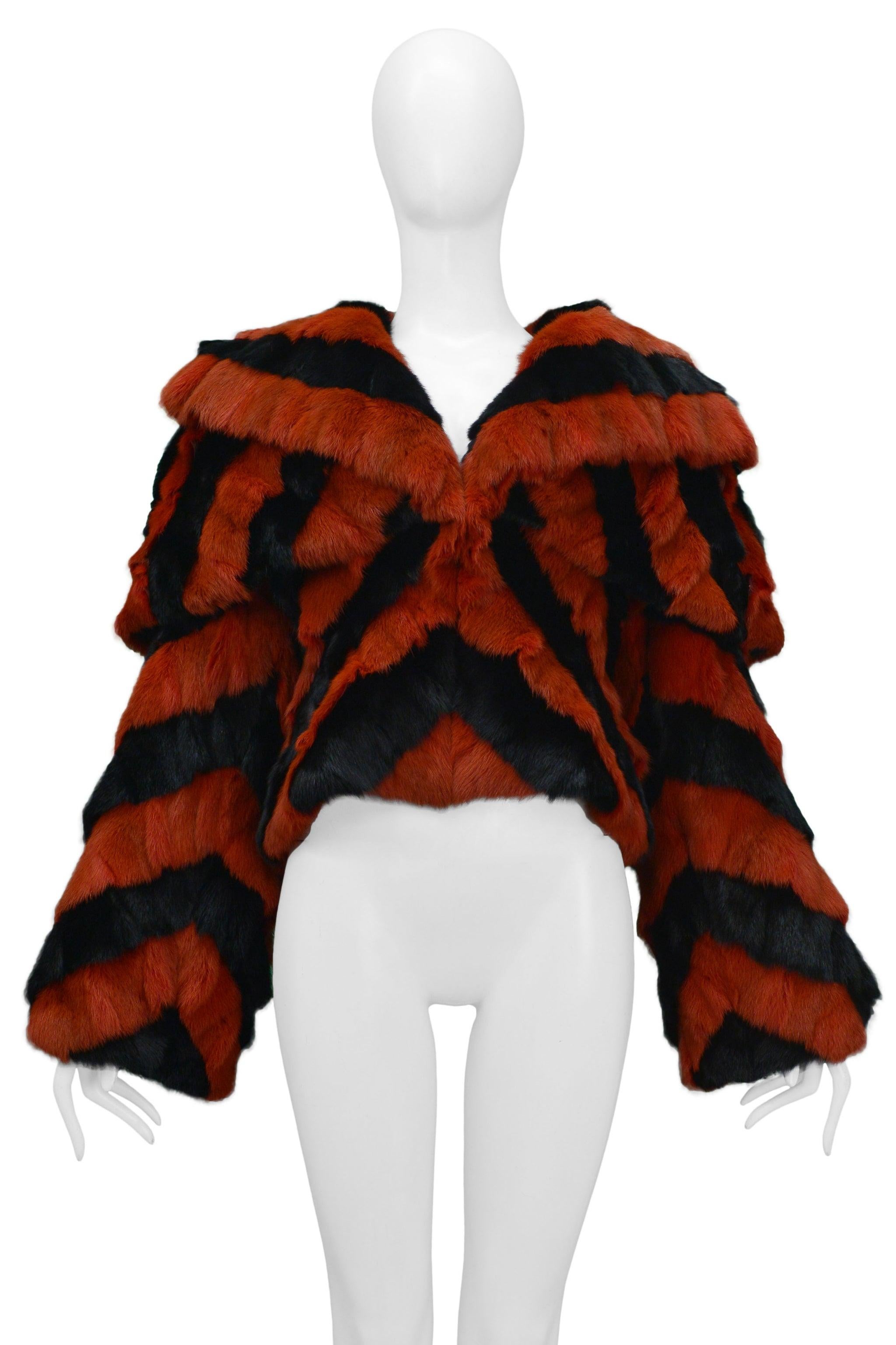 Resurrection Vintage is excited to offer an important Alexander McQueen black and red fur jacket featuring a graphic chevron design, double shawl, and bib collar, long sleeves, fitted body, and fully lined. It was shown on the runway in the 