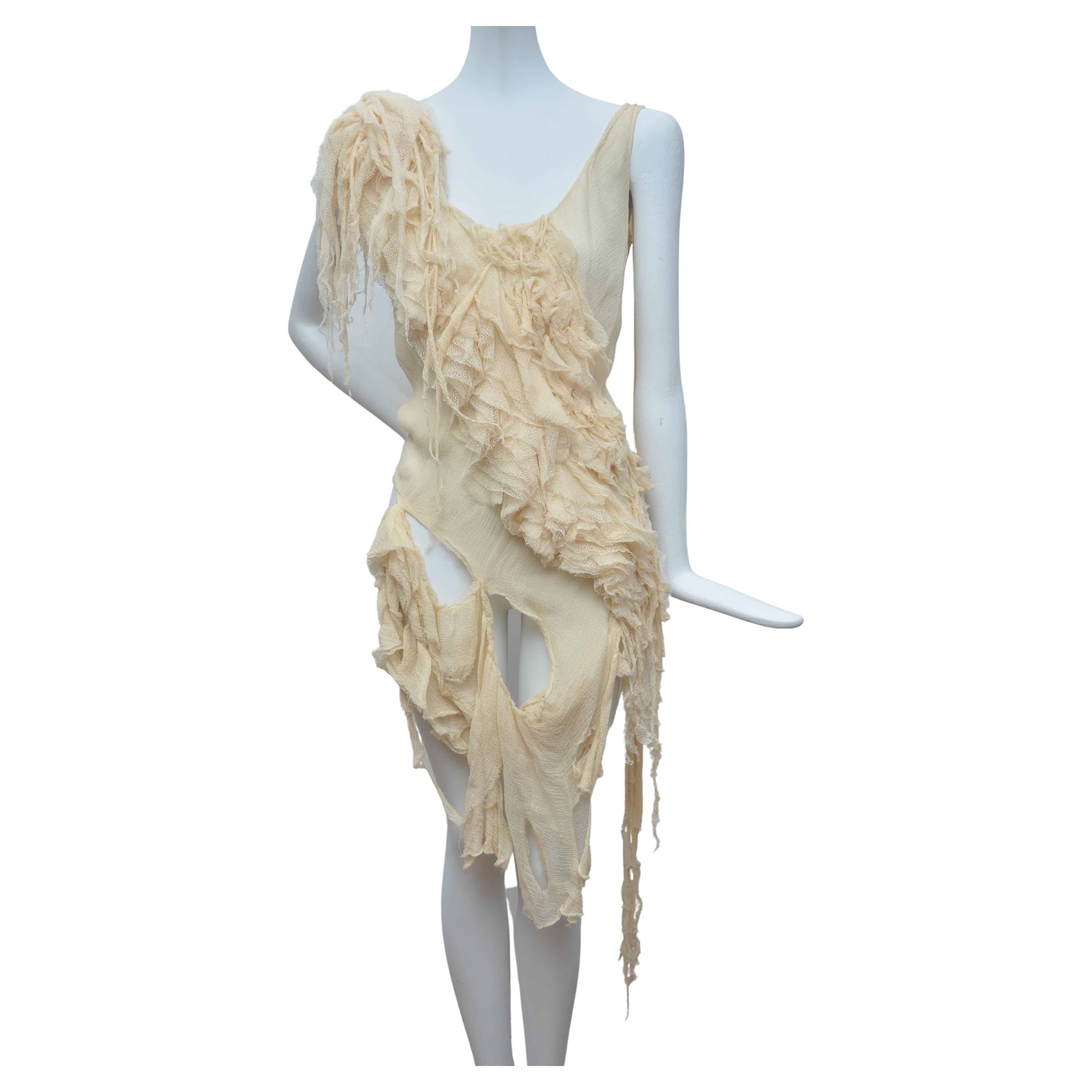Rare  ALEXANDER MCQUEEN SS03 Oyster beige raw distress ruffle drape top 
Size IT40 S  
Off white cream silk . Distressed frayed edges . 
Ruffle allover . Knotted and draped strands on left shoulder .
Irregular drapes . Raw cut fabric . Made in Italy