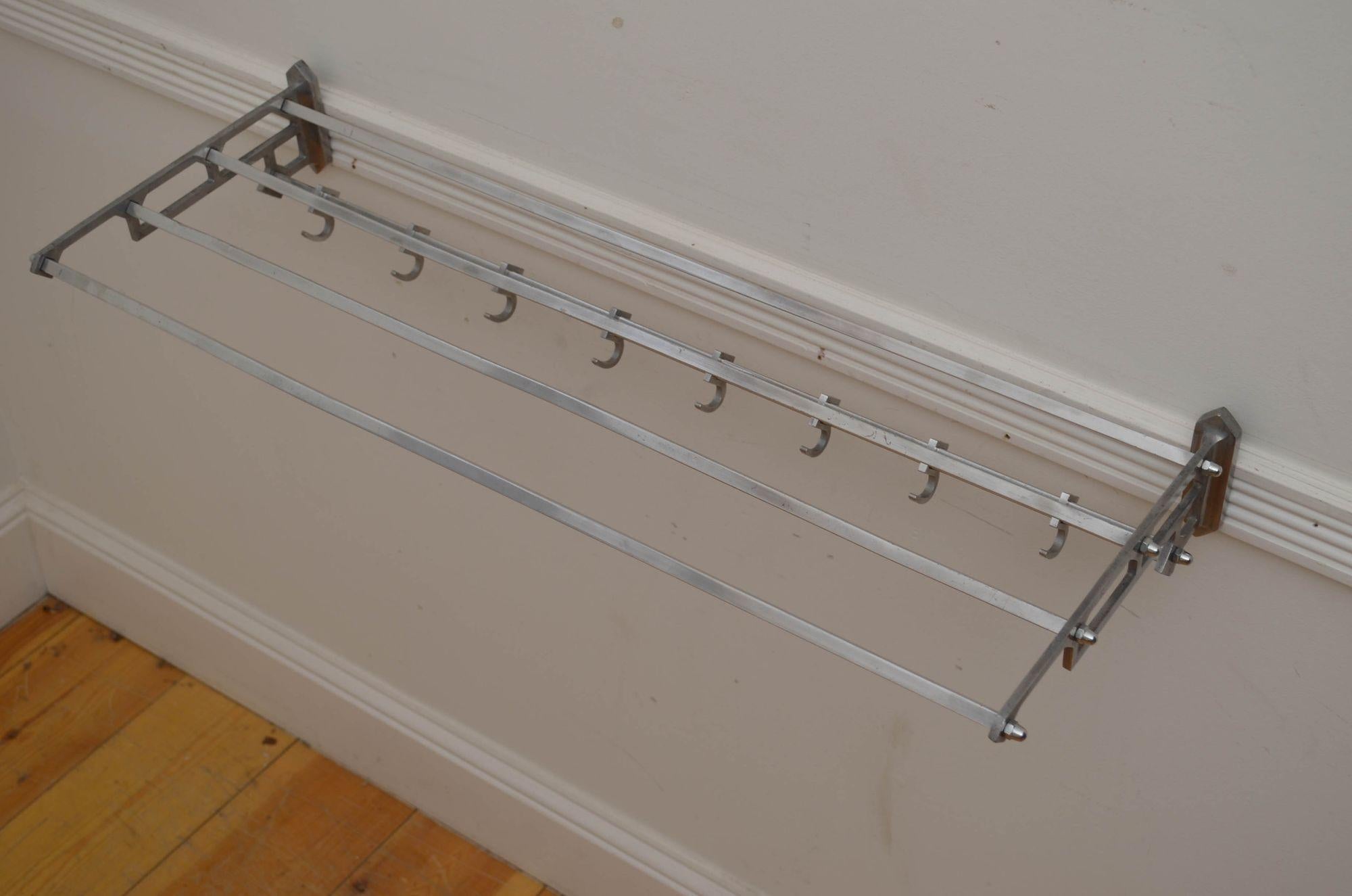 P0276 Stylish Bauhaus design, train style coat rack with a shelf, having eight adjustable hooks, four top shelf bars (with iron insets, making it very strong) and elegant stylized sides. This antique coat hook rack was cleaned and polished and is in