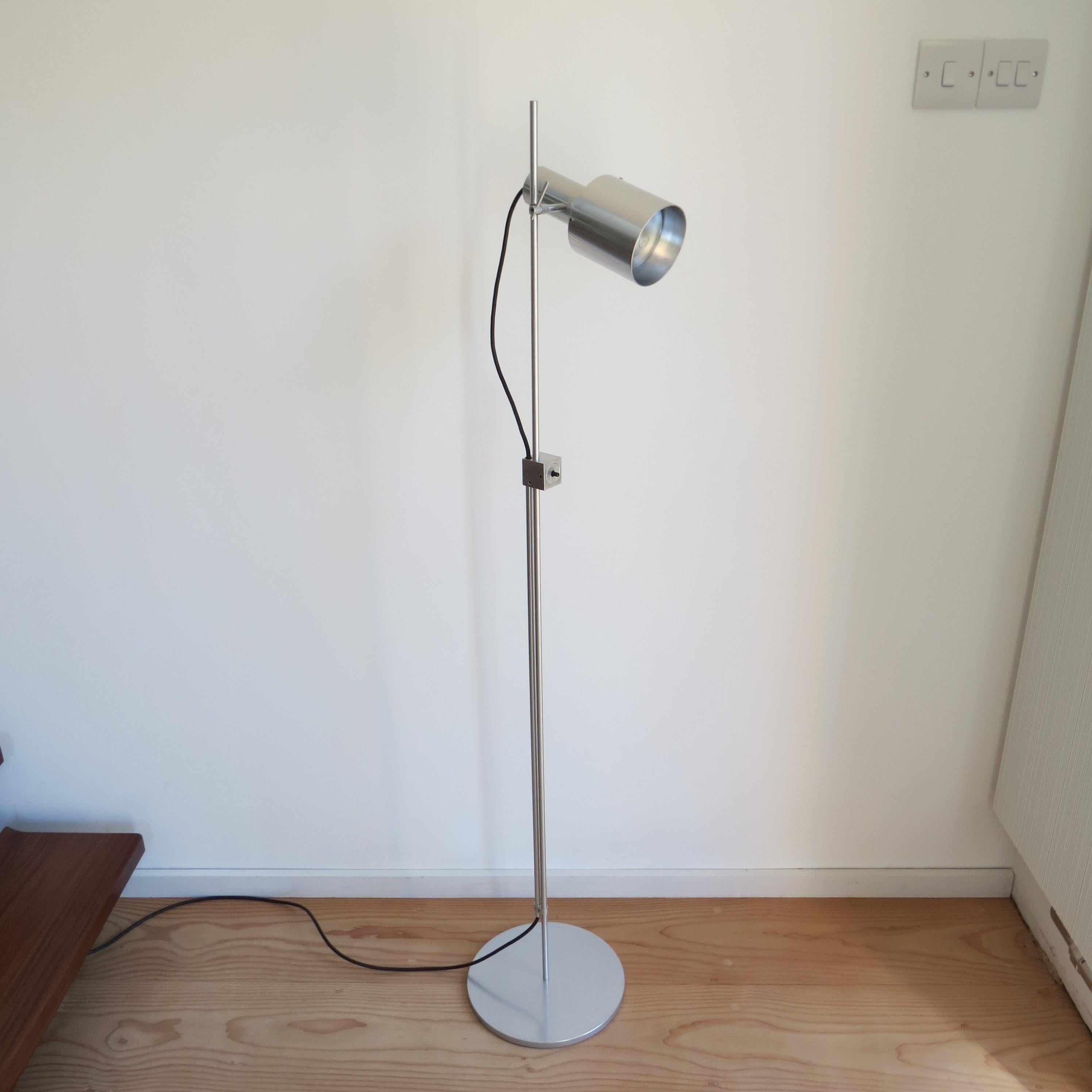 Rare aluminium floor lamp designed Peter Nelson and produced by Architectural Lighting Ltd. Date from the early 1960s. The lamp has a single spot adjustable lamp that moves up and down the rod and also tilts to the required angle. Made from solid
