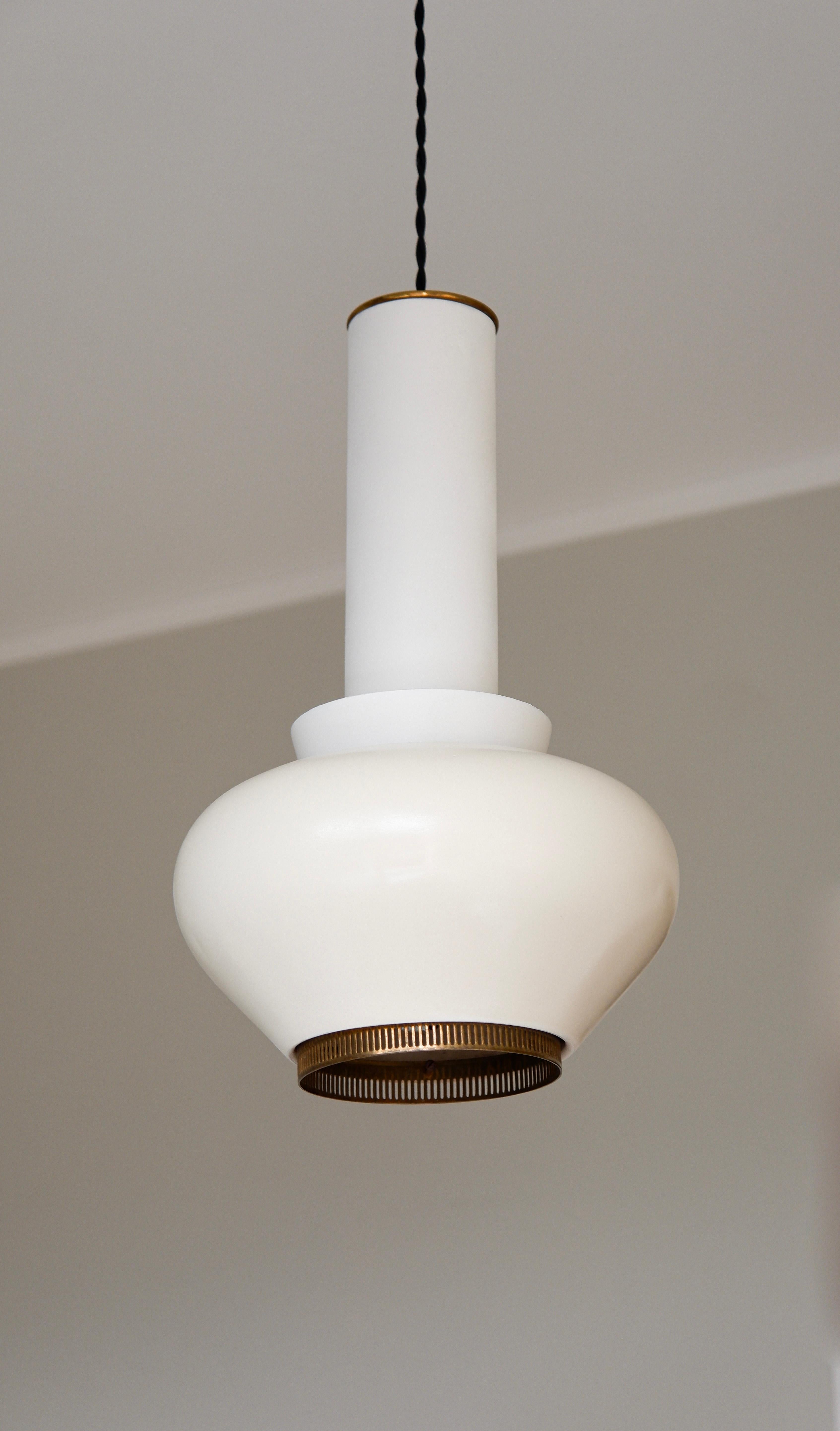 Iconica e rara lampada a sospensione modello A 334 disegnata da Alvar Aalto per Valaistustyö che rappresenta la prima edizione di quelle luci che non vengono più prodotte. La lampada è realizzata in ferro laccato con dettagli in ottone. Il paralume