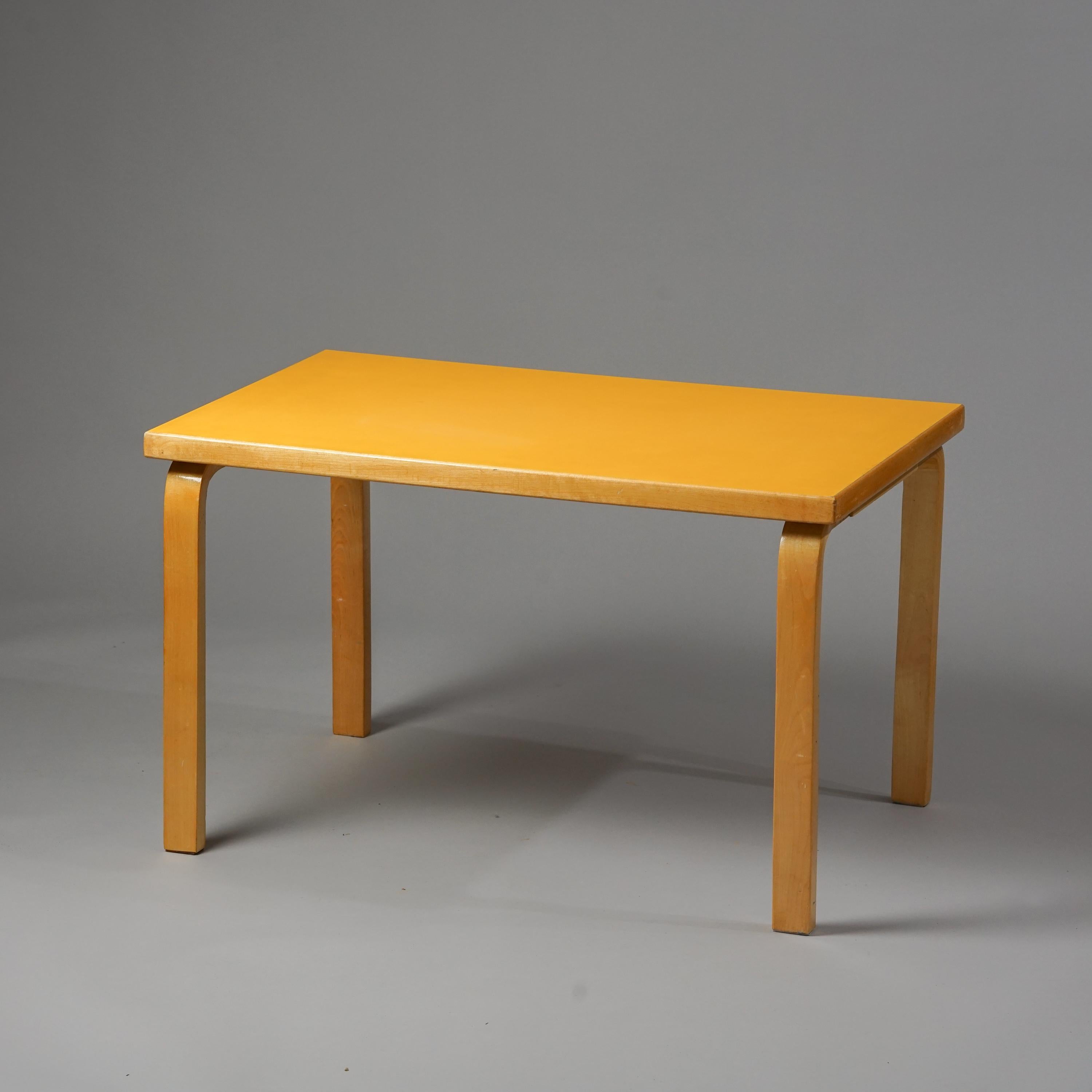 Alvar Aalto children's table for Artek from the 1960s. Lacquered birch and linoleum surface. Rare yellow colour. Good vintage condition, minor wear consistent with age and use. Classic L-legs. 

