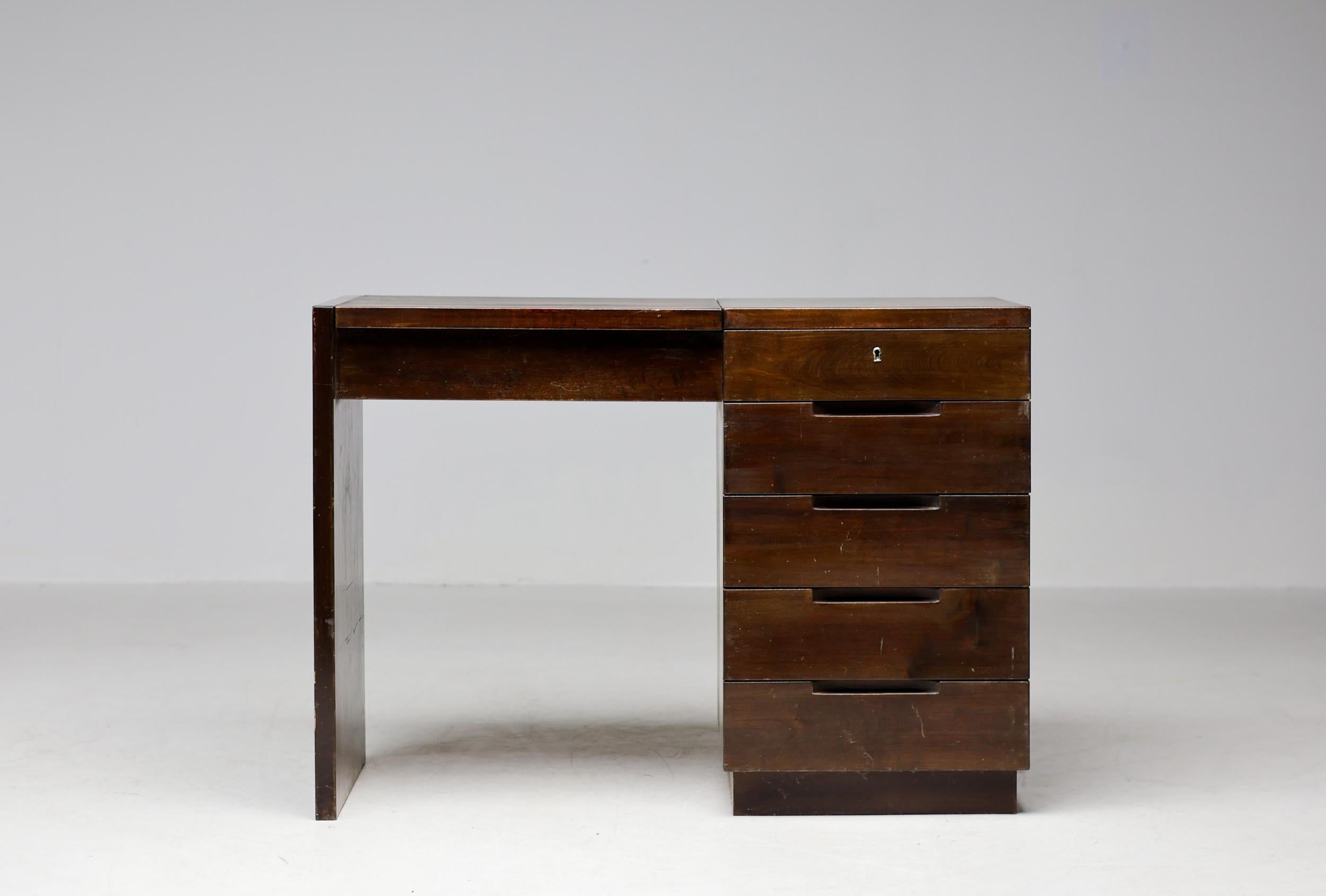 Almost a century later, from its original days of manufacturing, a dressing table designed by Alvar Aalto is extremely hard to find.  This particular piece is completely original, which is nothing short of a miracle. 
Executed in dark brown stained