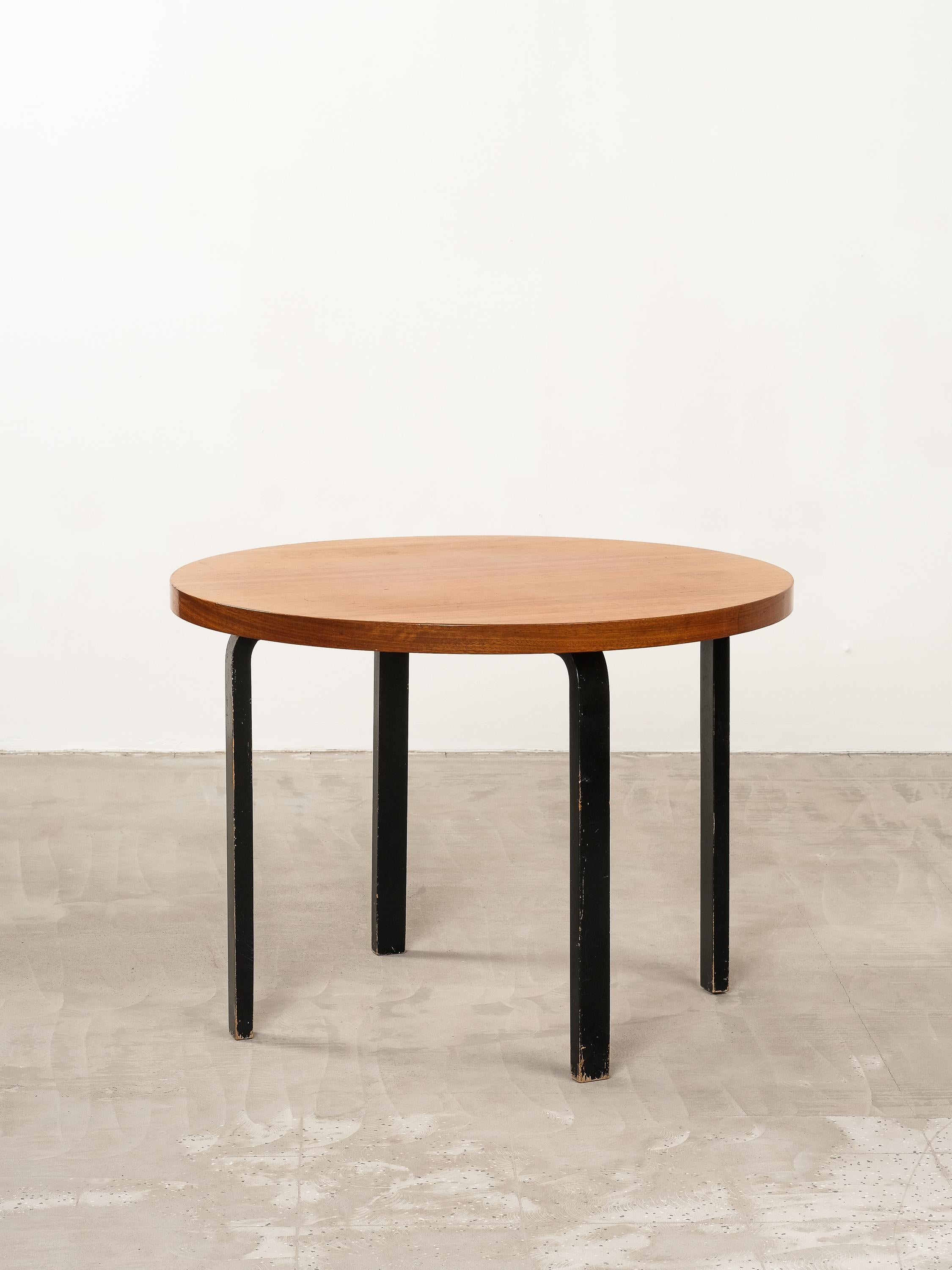 Alvar Aalto model 90 A round dining room table for Artek in the mid 1900s, rare teak top with black painted birch L-legs, good original vintage condition. Minor wear consistent with age and use. Iconic Alvar Aalto design.