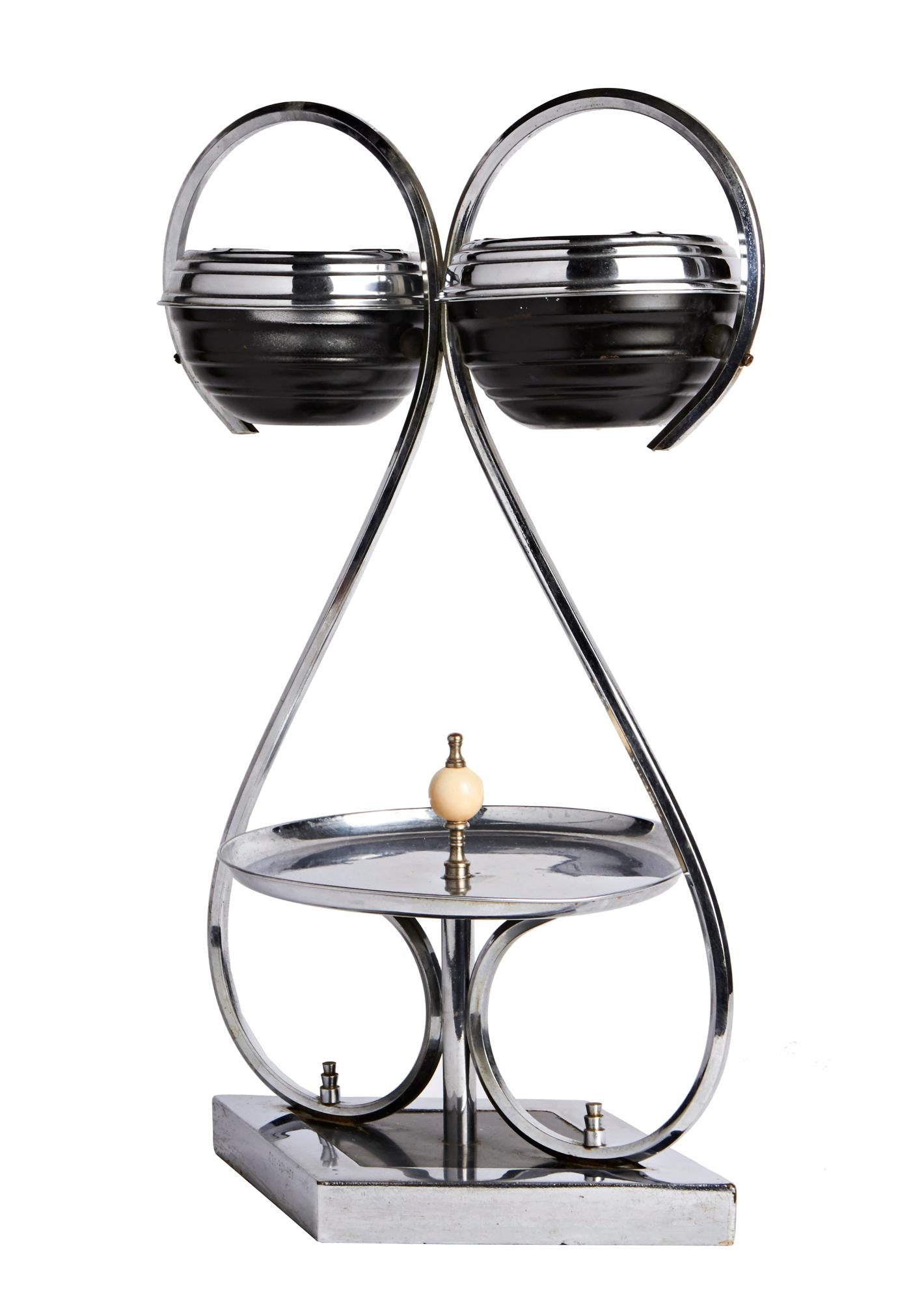 This rare and amazing Canadian chrome and black smoker's stand features twin ashtrays supported by chrome 