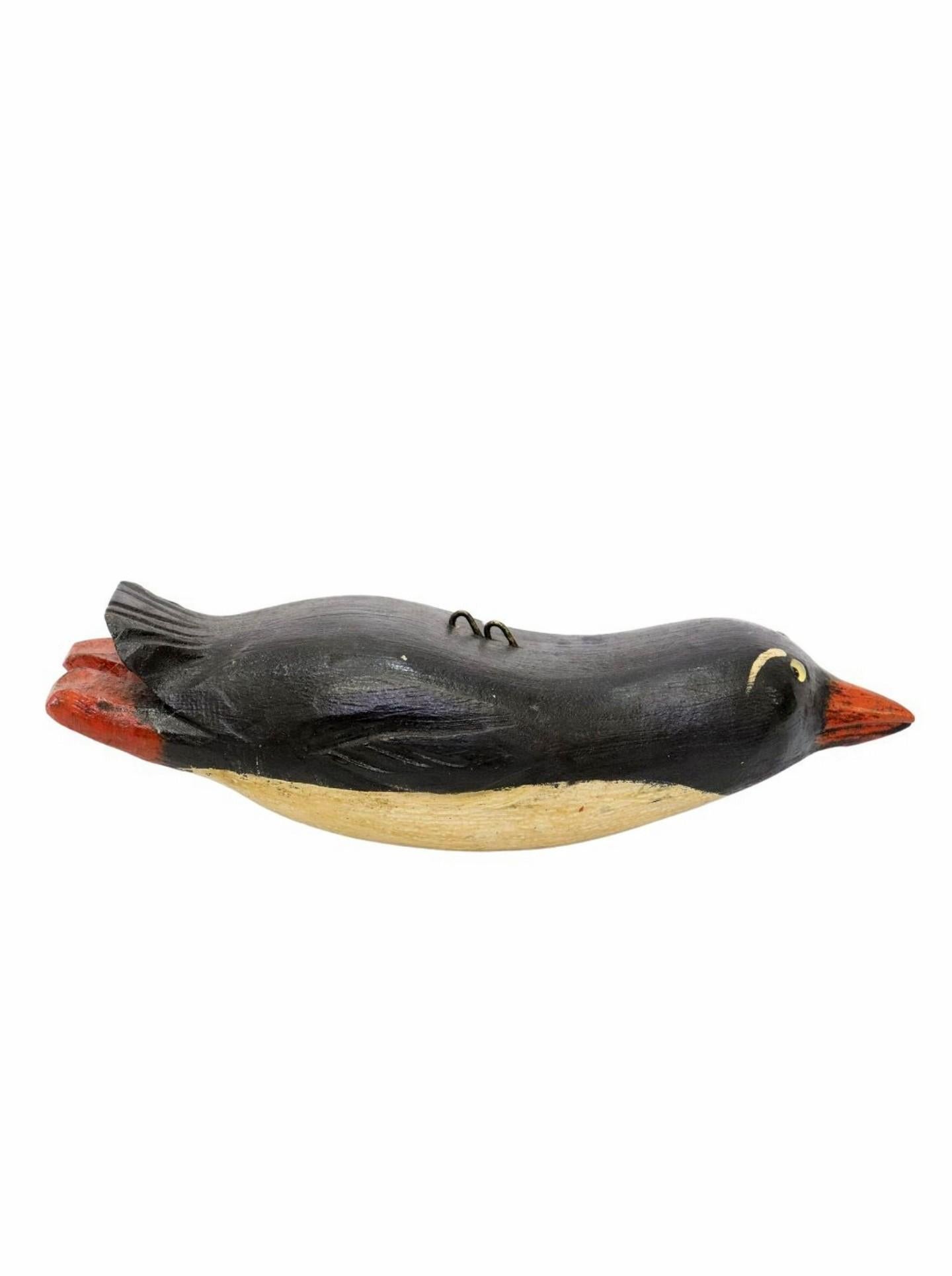 A large rare, one-of-a-kind, Duluth Fish Decoy American folk art sculpture, depicting diving penguin, hand-carved by the late David Earl Perkins (Duluth, Minnesota, 1934-2018), featuring the original hand-painted finish with black body, white