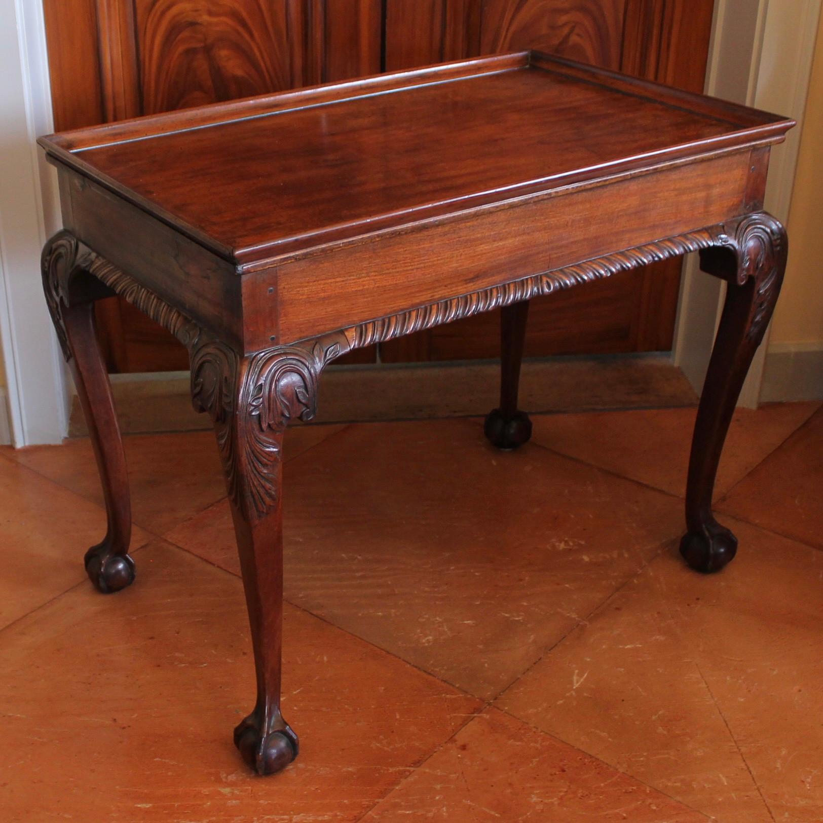 A rare and desirable form, with its tray top and the carving finished in order to be seen from all sides, the cabriole legs terminate in very well carved ball and claw feet. The knees are carved with acanthus, in a manner closely related to Irish