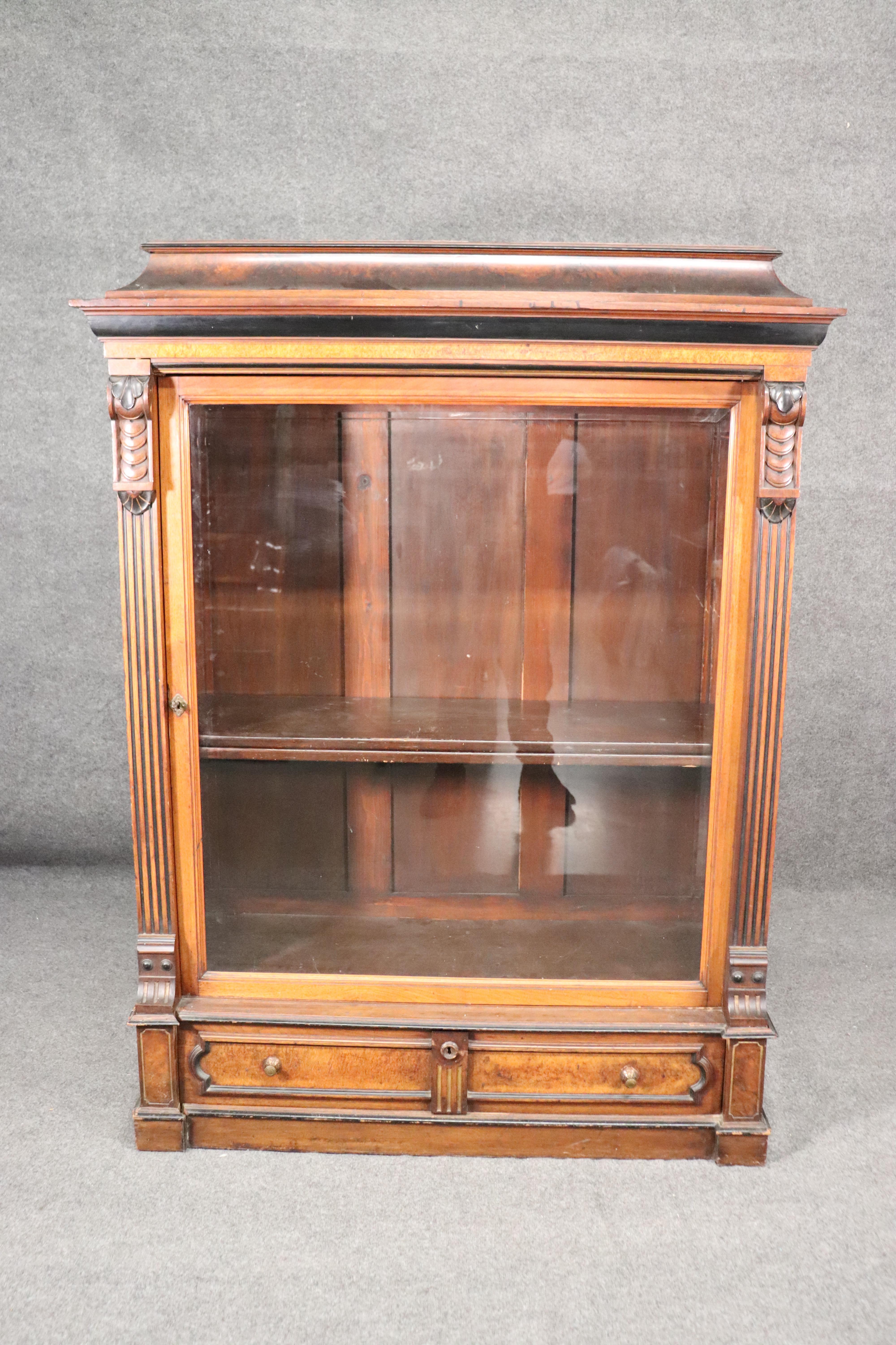 This is a gorgeous bookcase or vitrine measuring 66 inches tall x 51 wide x 19 inches deep. The condition of the piece is very good considering its approximately 150 years old. The cabinet is burled walnut and done in the Renaissance Revival style