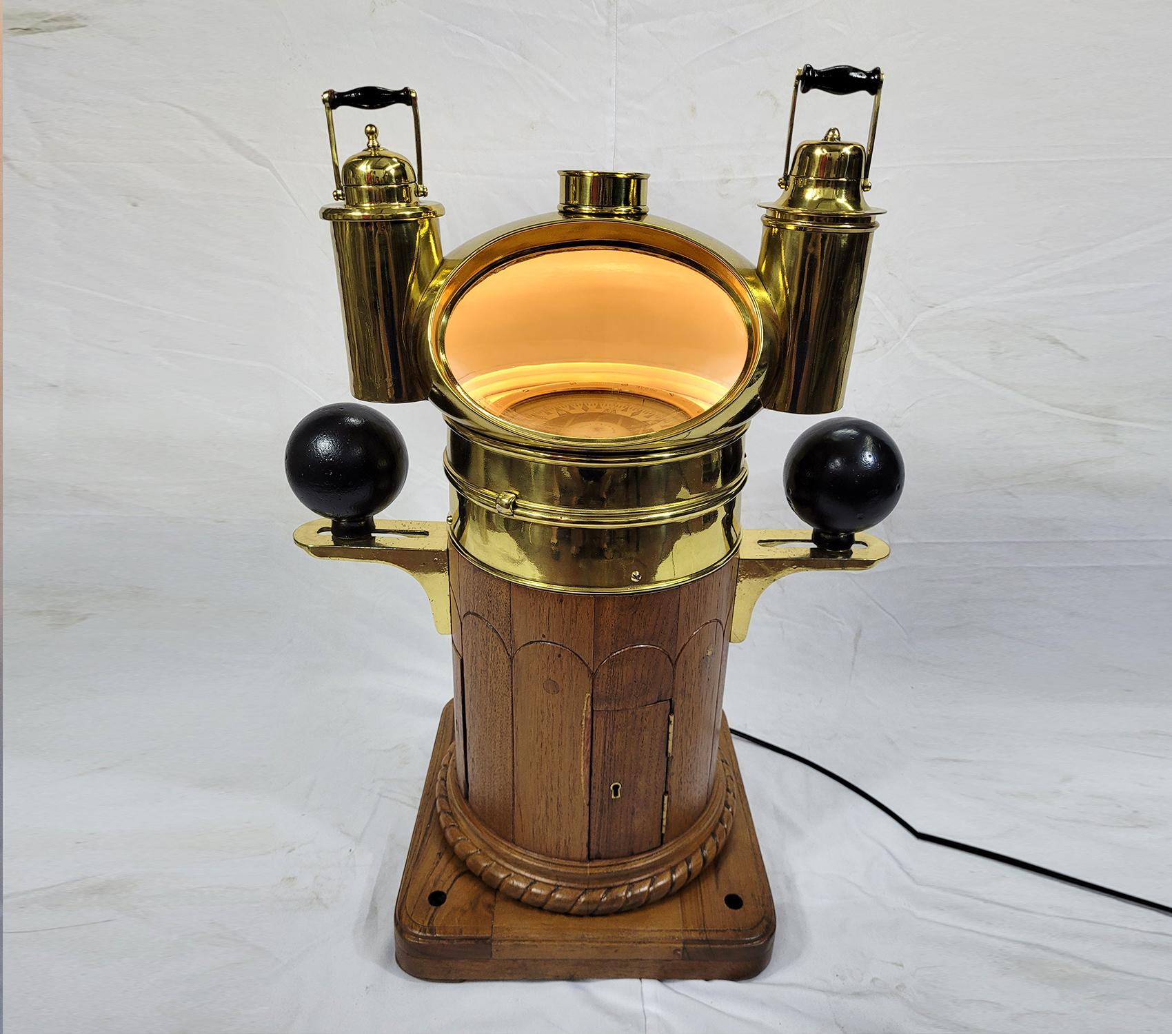 Absolutely awesome yacht binnacle by New York maker T.S & J.D Negus of New York. Varnished base with intricate rope carving. The brass binnacle carries 2 oil lanterns, Iron compensating balls are mounted to brass brackets. This is a fabulous