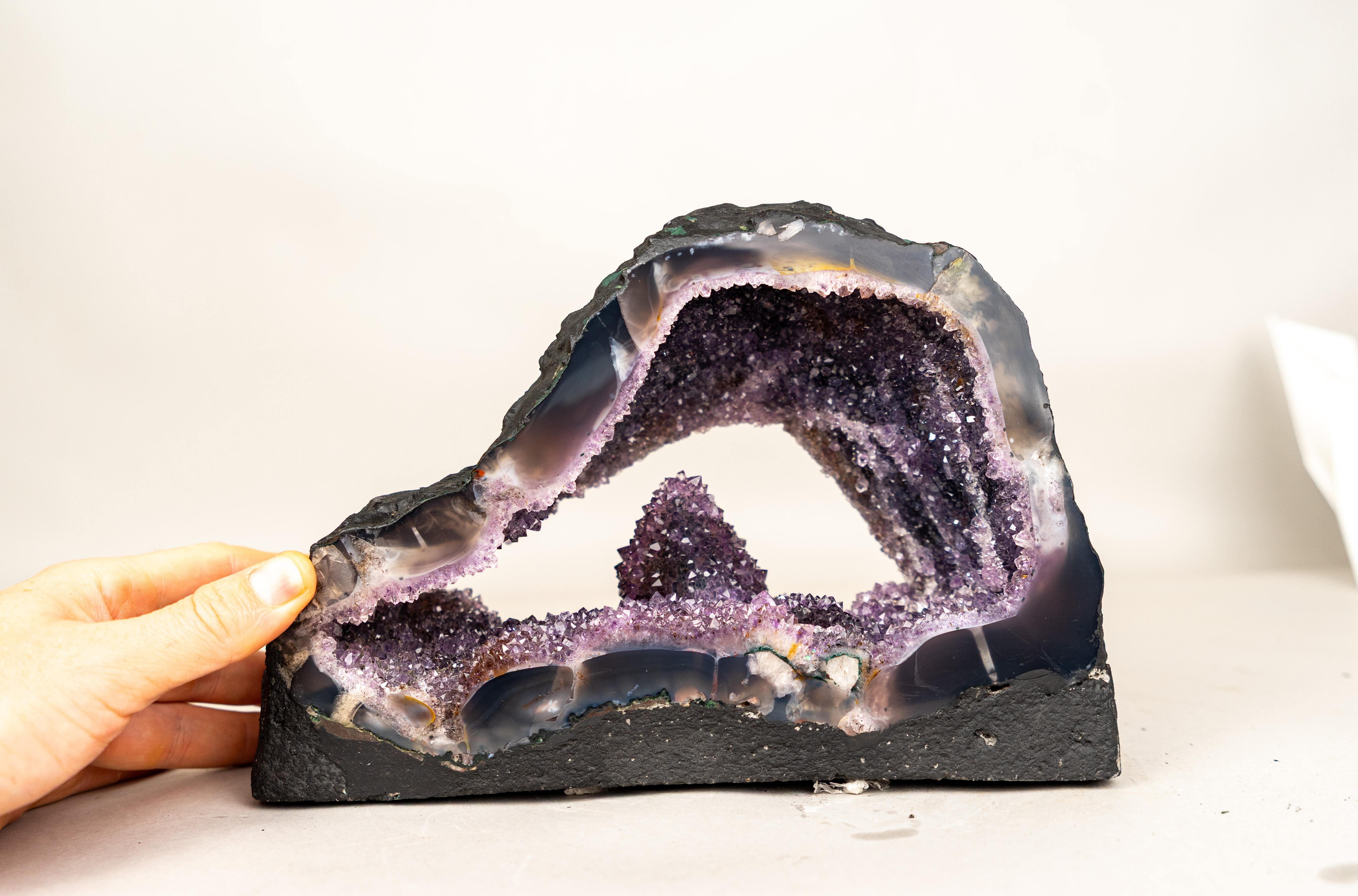Gallery-Grade Amethyst Geode with a Rare Intact Calcite on Galaxy Amethyst 

▫️ Description

Among the thousands of geodes discovered in Brazil each year, this specimen is a true rarity. A calcite crystal first took shape atop the agate base, and in