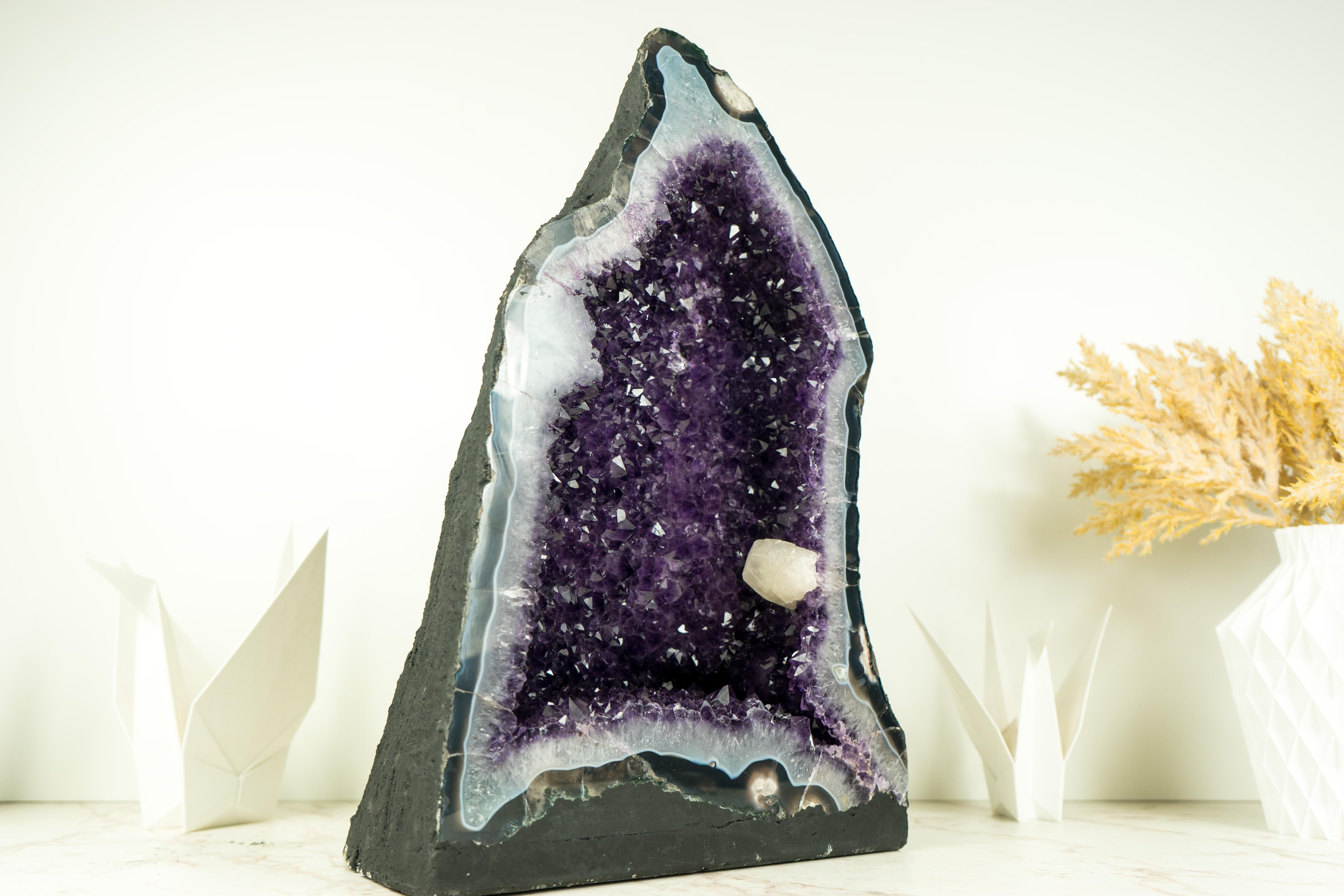 A geode that stands as an impressive natural sculpture, with calcite, deep purple, and shiny amethyst, and an aesthetical calcite inclusion interlacing that forms a unique display of natural artistry, a centerpiece.

Rarely seen in any Amethyst