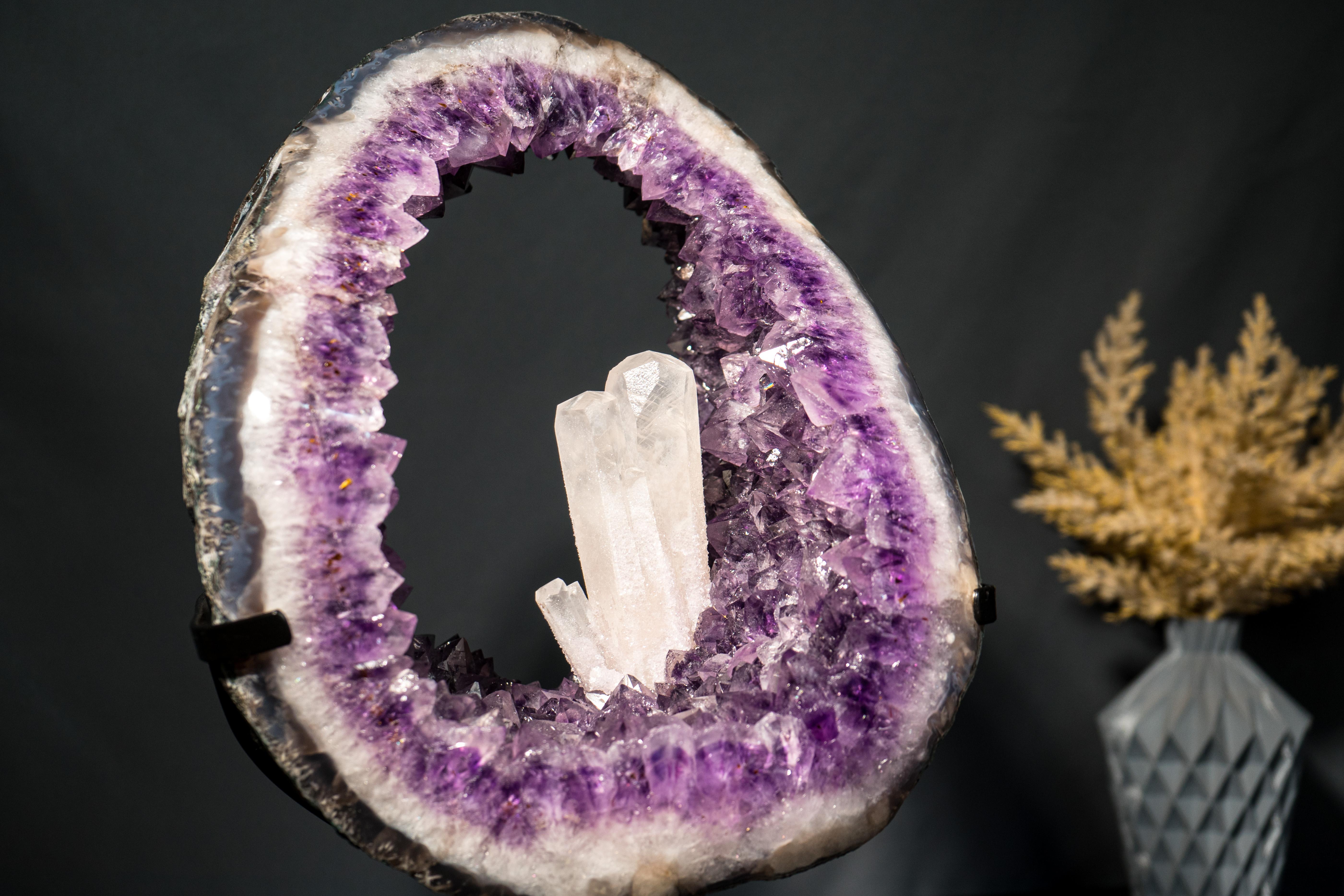 A Superb Aesthetical Prismatic Calcite from Brazil

▫️ Description

Sculptural, aesthetic, and perfect, this Amethyst Geode Portal features a rare inclusion of Calcite that stands upright at the center of the ring, creating a dramatic composition of