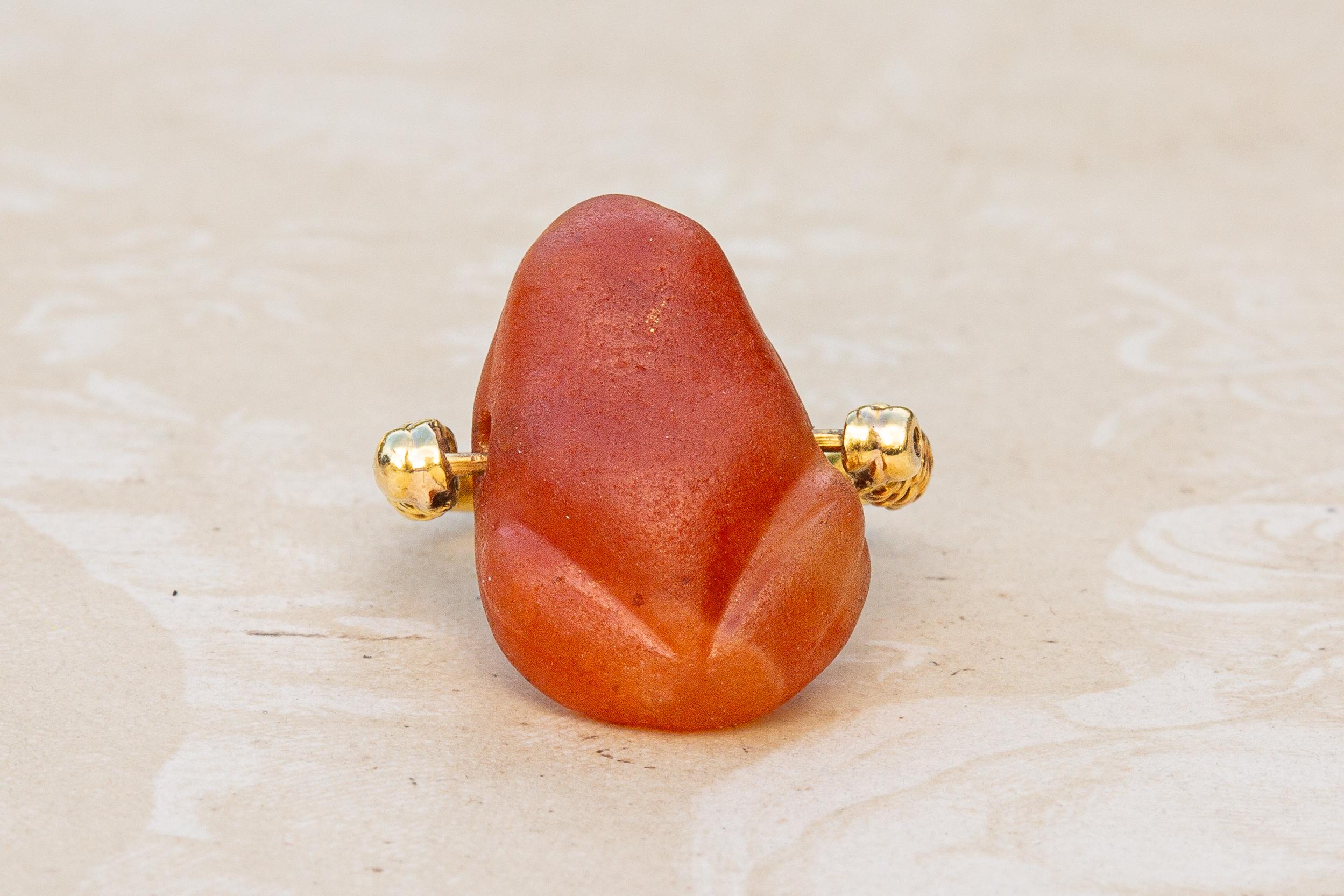 This rare Egyptian carved carnelian frog amulet dates to the Eighteenth Dynasty of the New Kingdom, circa 1300 BC. Frog amulets, depicting the goddess Heket, were commonly worn by both the living as a fertility charm and the dead to provide