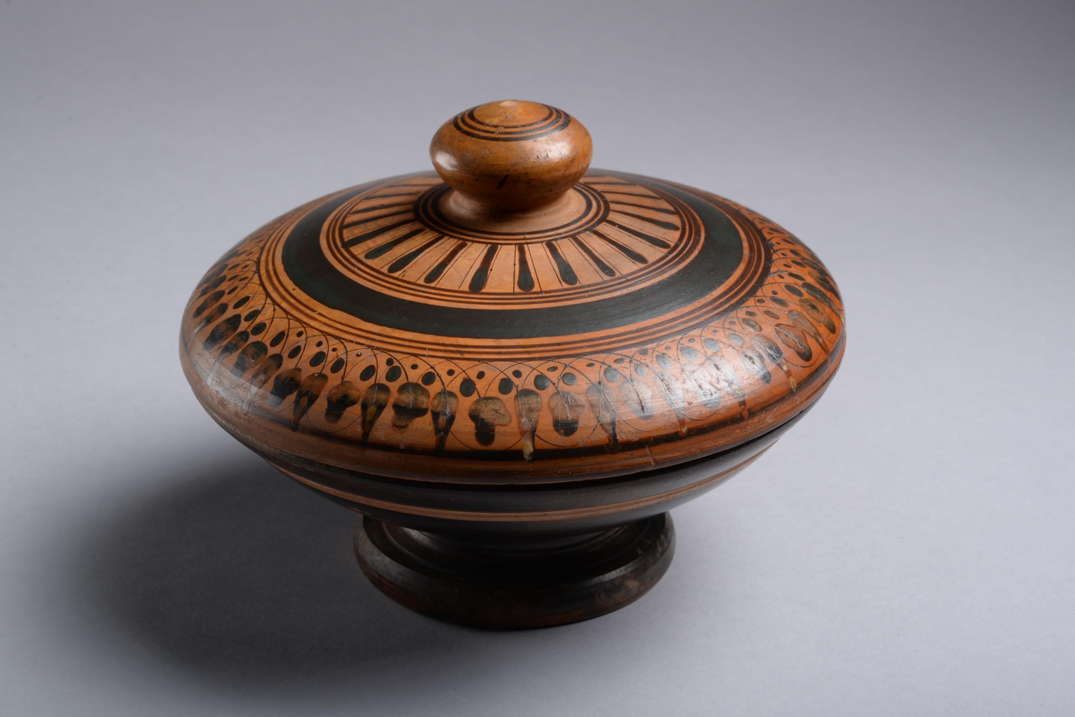 A rare Colonial Greek or Etruscan Attic black-figure Pyxis
Circa 6th century B.C. 
Terracotta

Finely moulded, the cover with rounded knob and reserved decoration of concentric circles, the body of the lid with further black glazed concentric bands