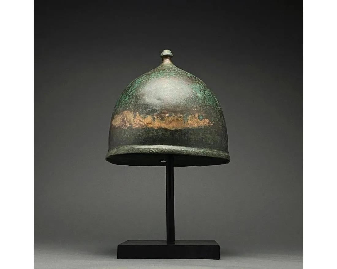 Ca. 100-50 BC. Roman. 

A very rare gilded bronze Montefortino bronze helmet with a rounded bowl, folded brim and projection on the top for attaching a plume. The Monterfino-type helmet was a mainstay of Roman soldiers during the Roman Republic,