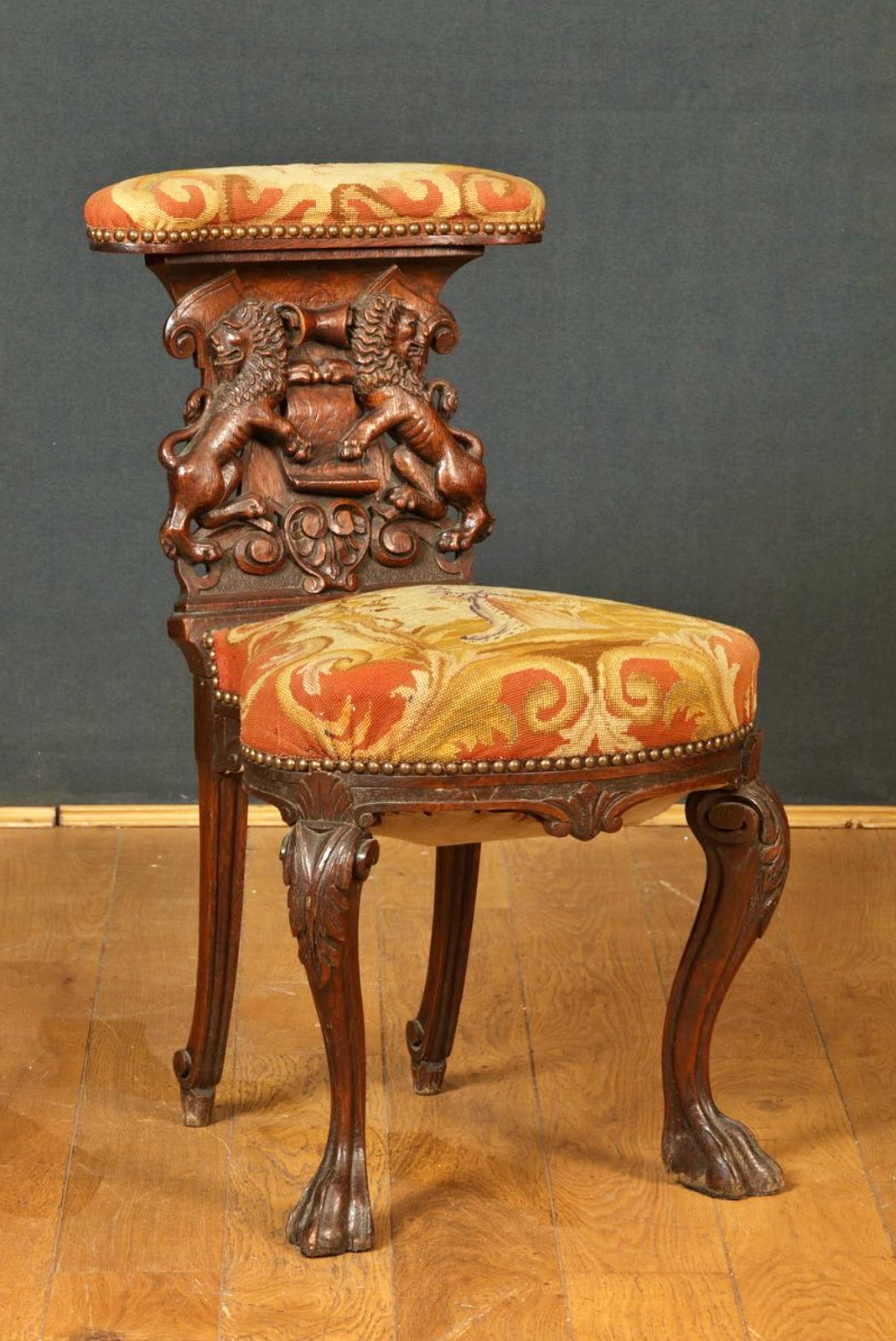 RARE and AMAZING CHAISE VOYEUSE England Circa 1860 

in stained and carved oak decorated with two lions framing a phylactery, cambered legs with acanthus leaves and claw. Tapestry upholstery decorated with a PD monogram and a young girl in