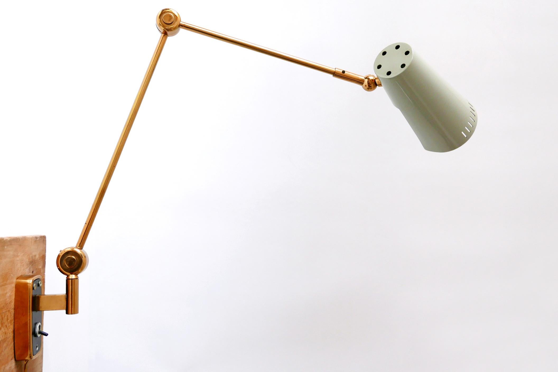 Extremely rare and articulated Mid-Century Modern wall lamp. Designed and manufactured by Stilnovo, 1950s, Italy. Marked four times to the arm and inside of the shade. The lamp can be adjusted in various position.

Executed in brass sheet and tubes,