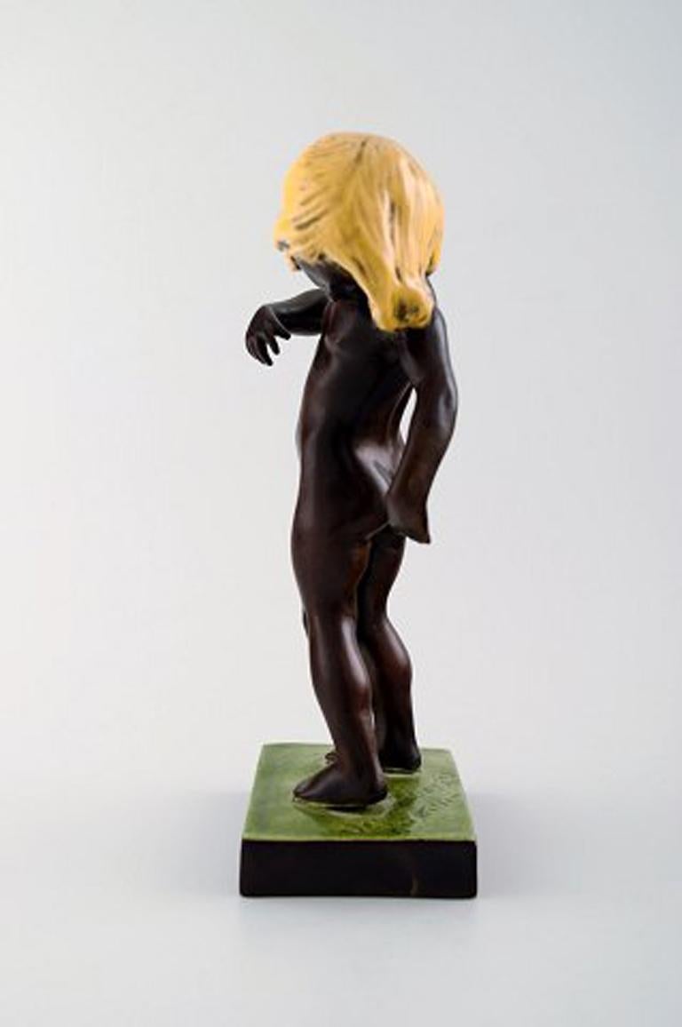 Rare and early P. Ipsen's, Copenhagen, girl 888. Venus Kalipygos, Design Kai Nielsen. 1928. In brown glaze with yellow hair.
Measures: 22 cm.
In perfect condition.