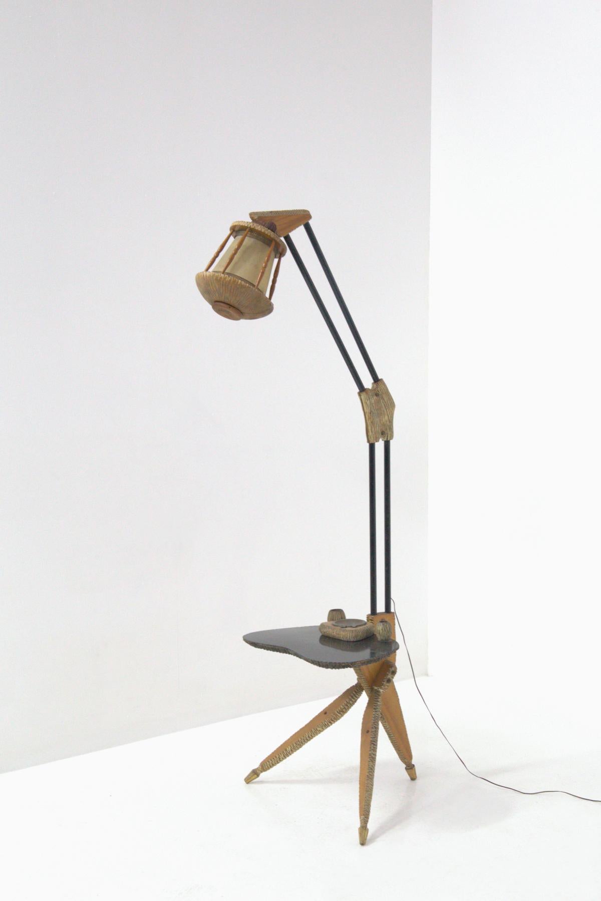 Eccentric and futuristic floor lamp made by the great wood and parchment designer ALDO TURA from the 1950s. The lamp is made with many and precious peculiarities and also different realizations. In fact through the complexity it can be called a true