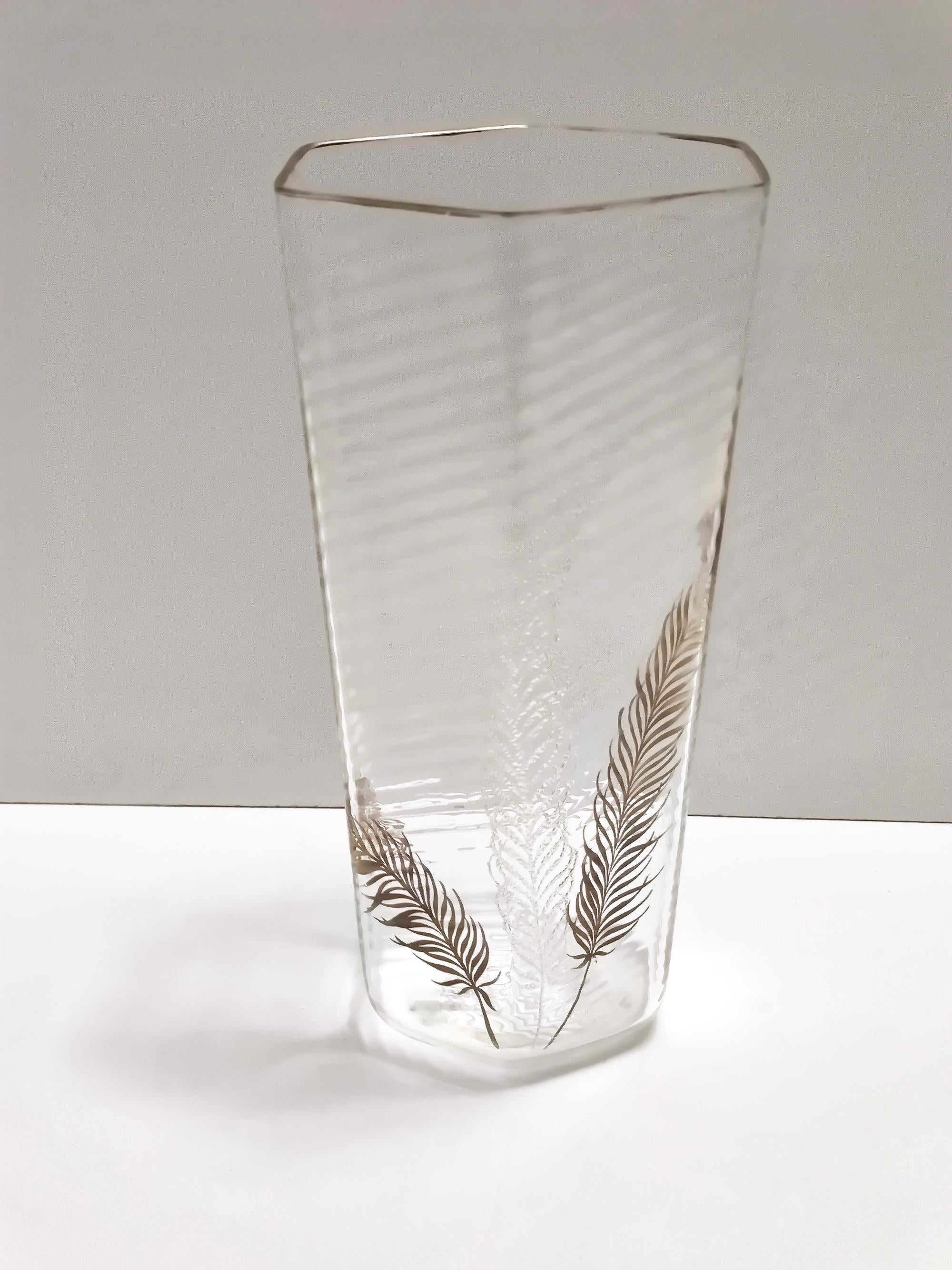 Made in Italy, 1950s.
This rare and elegant vase by Cenedese is made in thin turned Murano glass.
The conical hexagonal section was obtained by manual mold blowing, with hot-applied pure gold edging and leaves, and glass leaf in relief.
It is a