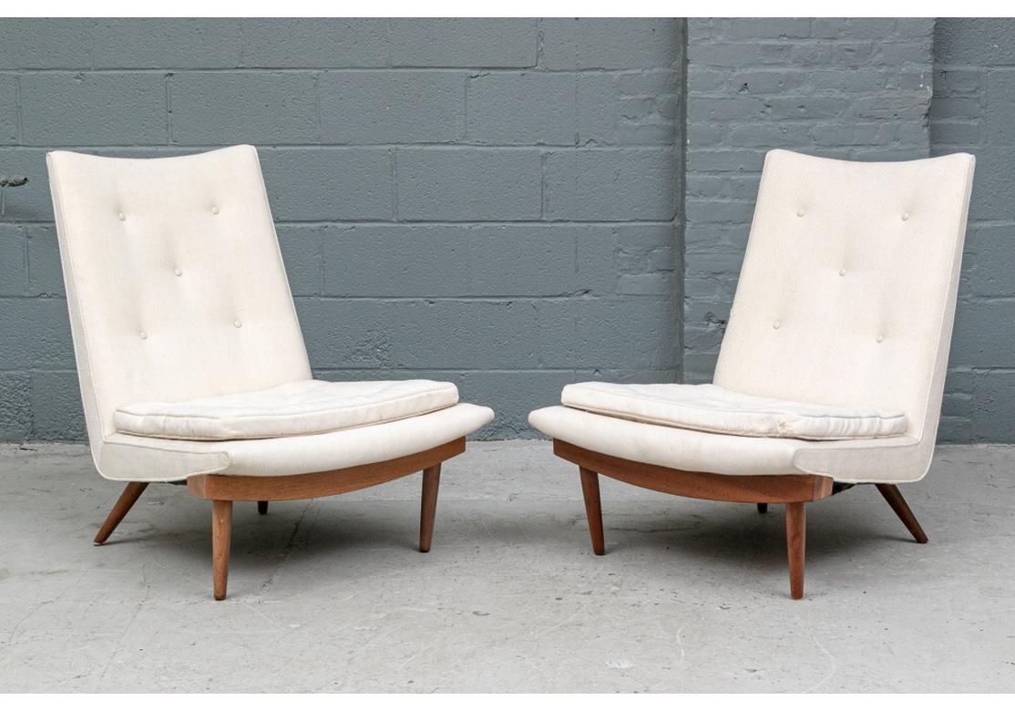 Extraordinary pair of George Nakashima lounge chairs crafted in American walnut and having some elaborate handwork dating to the earlier 1960’s. The light feet and frame combined with the generous seating cushions provide style and comfort. The