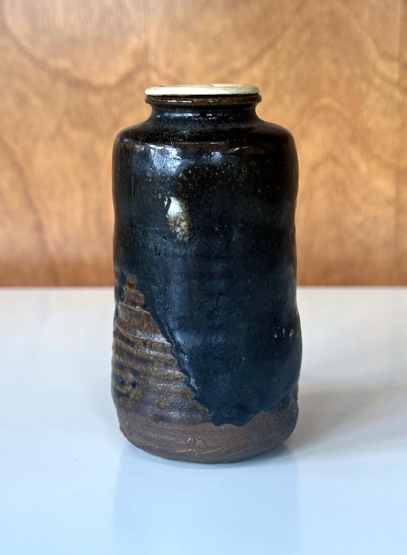 A ceramic tall chaire (Tea caddies) ko-satsuma type from Edo period Japan circa 18th century. This type of small jar was made of stoneware. Its specific form with raised shoulder and a small opening was specifically designed to store green tea