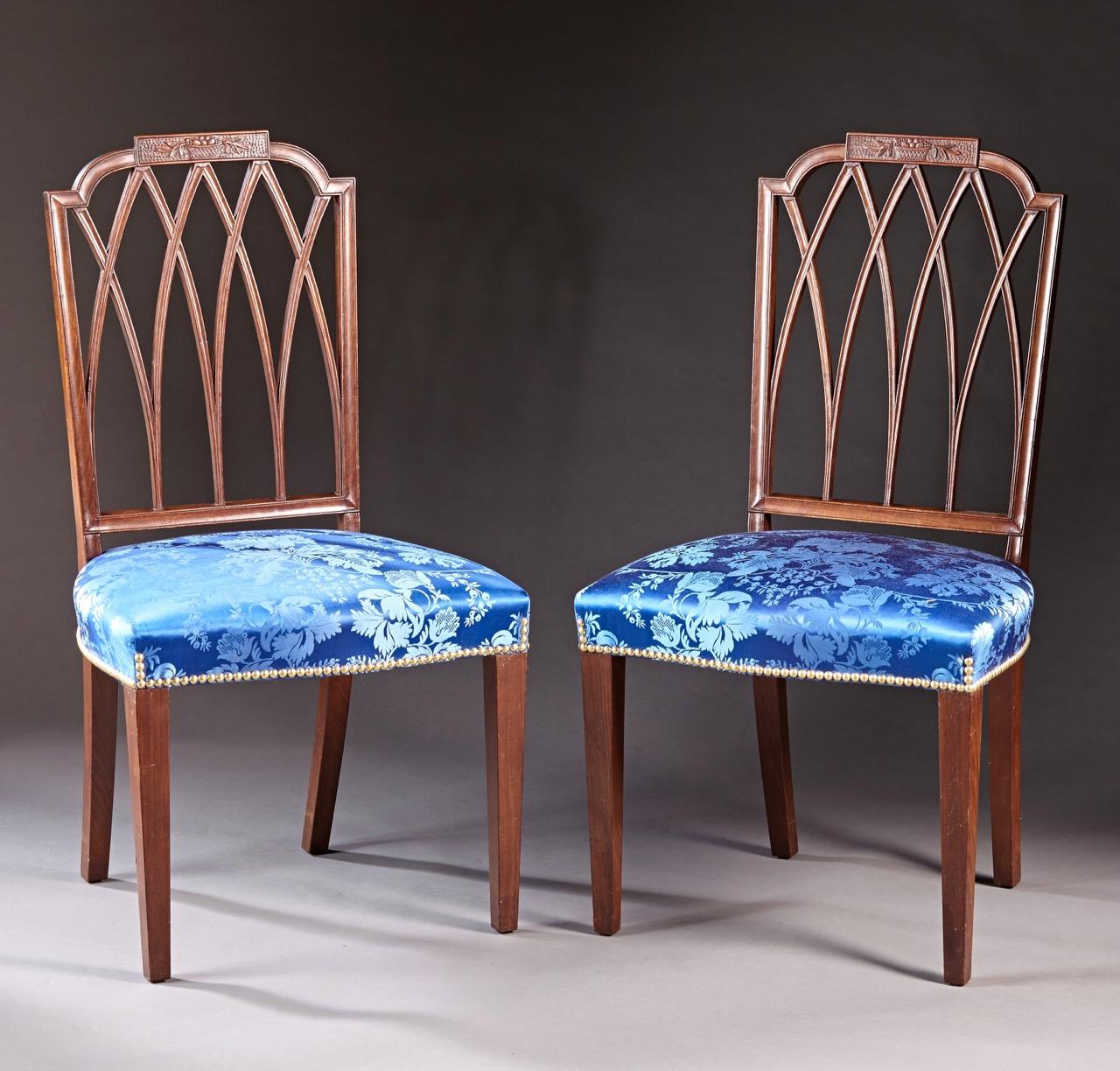 A very rare set of six Massachussetts mahogany Hepplewhite period chairs carved by Samuel McIntire. The crests with punchwork backgrounds are relief carved with baskets of fruit and foliate sprays over interlaced backs with channel molding on