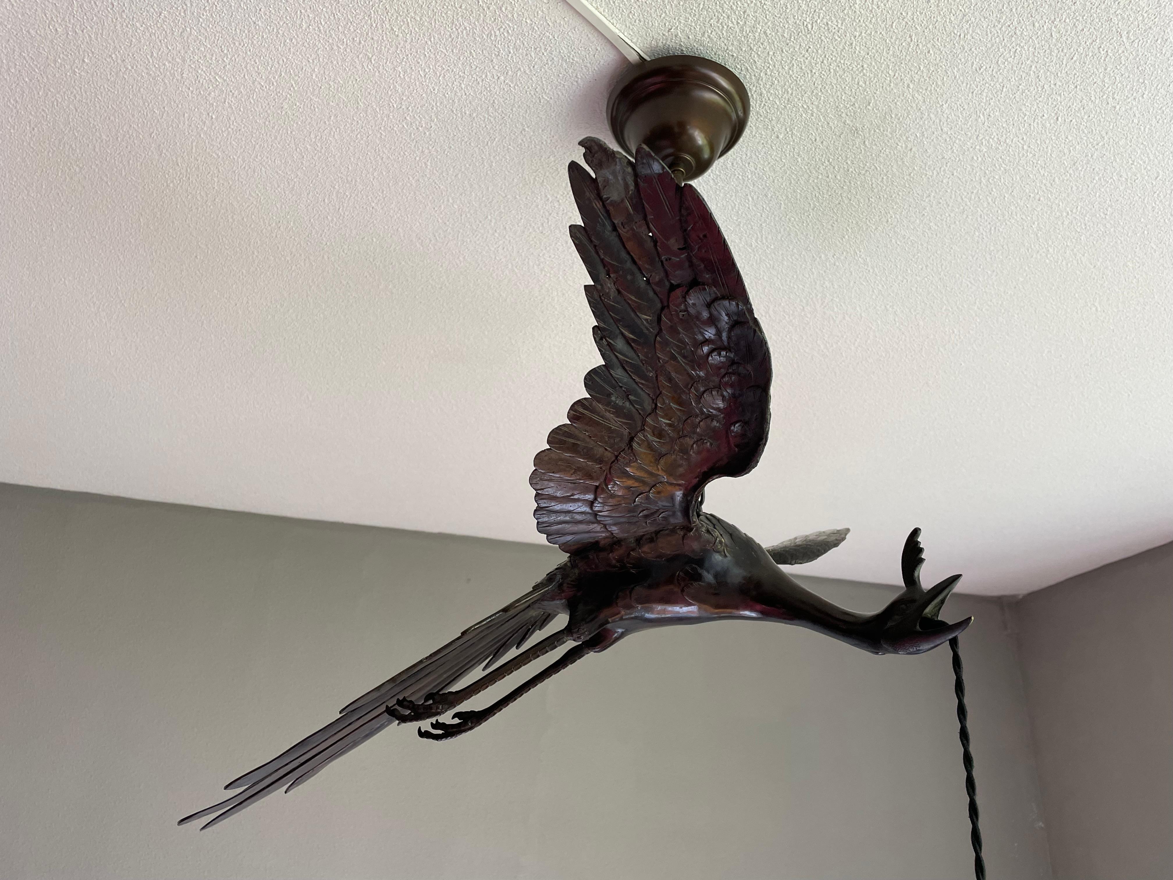 European Rare and Graceful Arts and Crafts Bronze Flying Crane Bird & Glass Shade Pendant For Sale