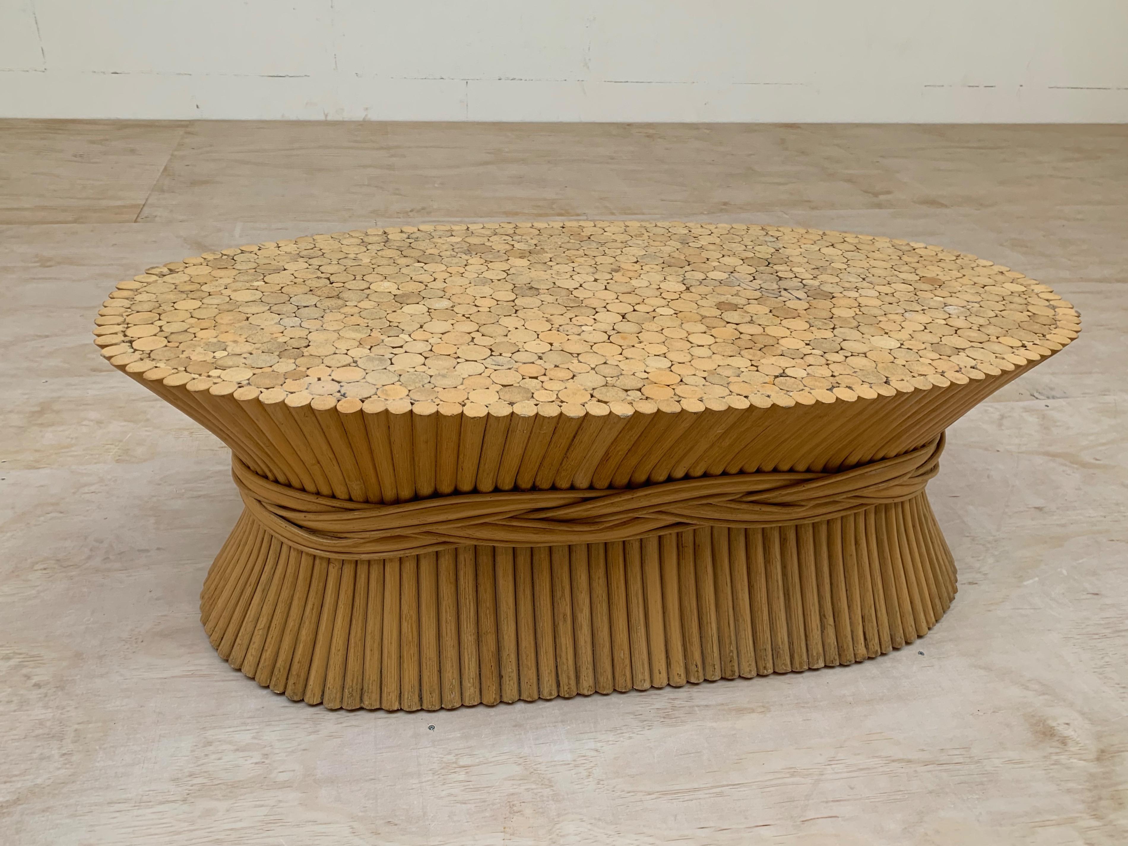 Original midcentury made, oval shape McGuire table.

This decorative and organically stylish table has the perfect look of being cinched into a sheaf of wheat. The wooden shafts of this rare design and sturdy table are stylishly encircled by a